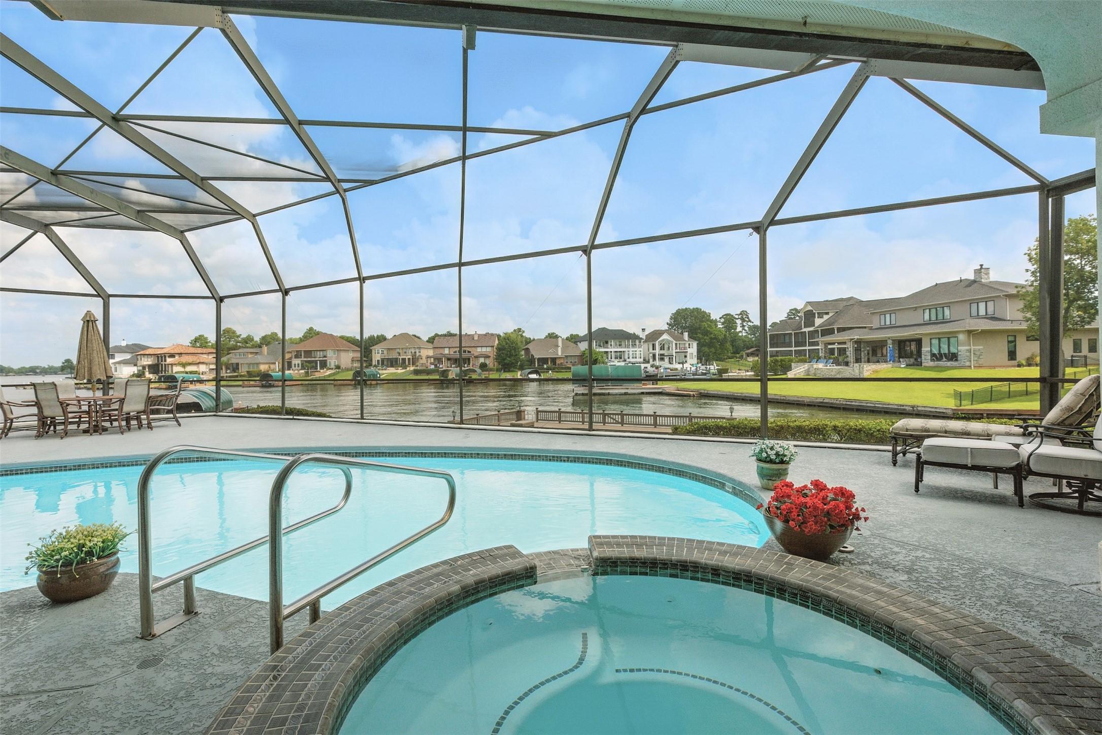 Image 2: Screened in pool/hot tub with cool touch patio .