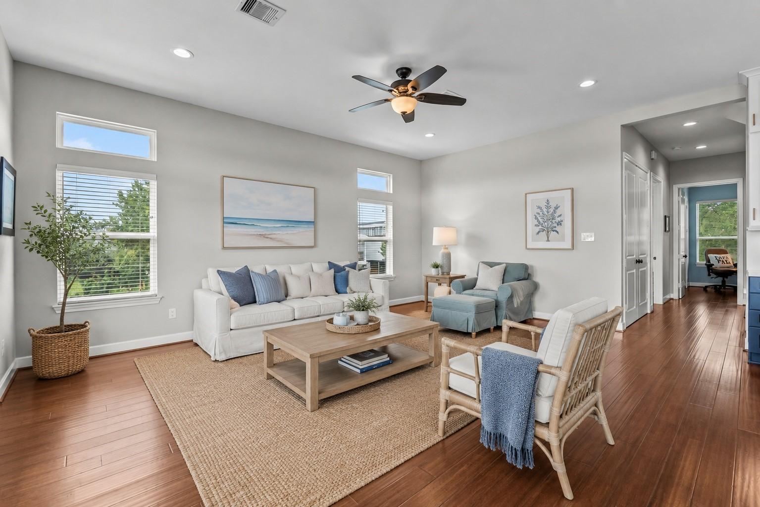 Image 4: Spacious living room offers a light-filled, open l