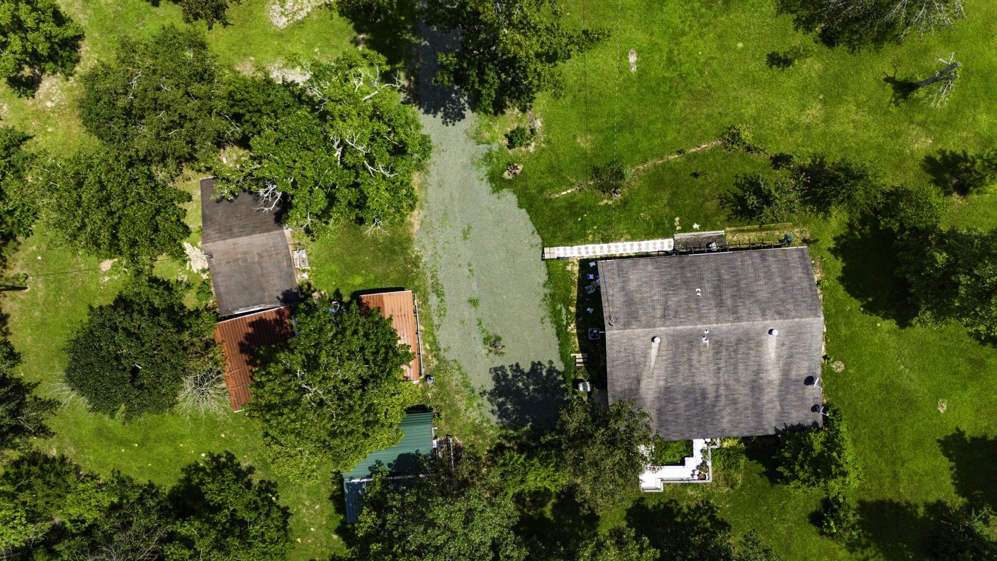 Image 3: This aerial photo showcases a spacious property wi