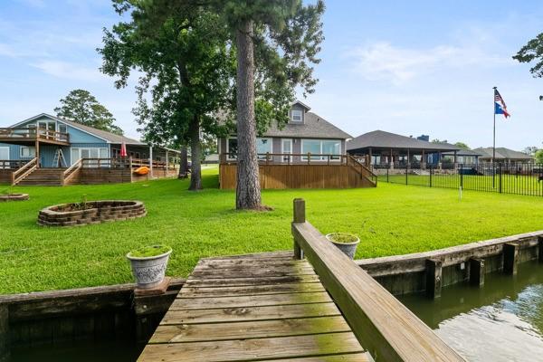 Image 1: A charming waterfront home with a spacious backyar