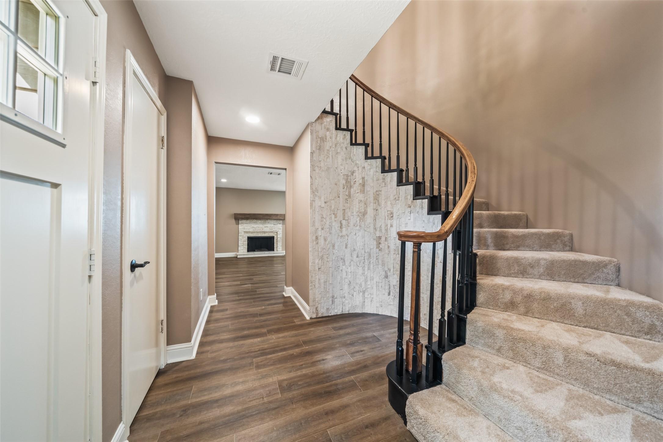 Image 4: Curved stairway with a stone accent that repeats o