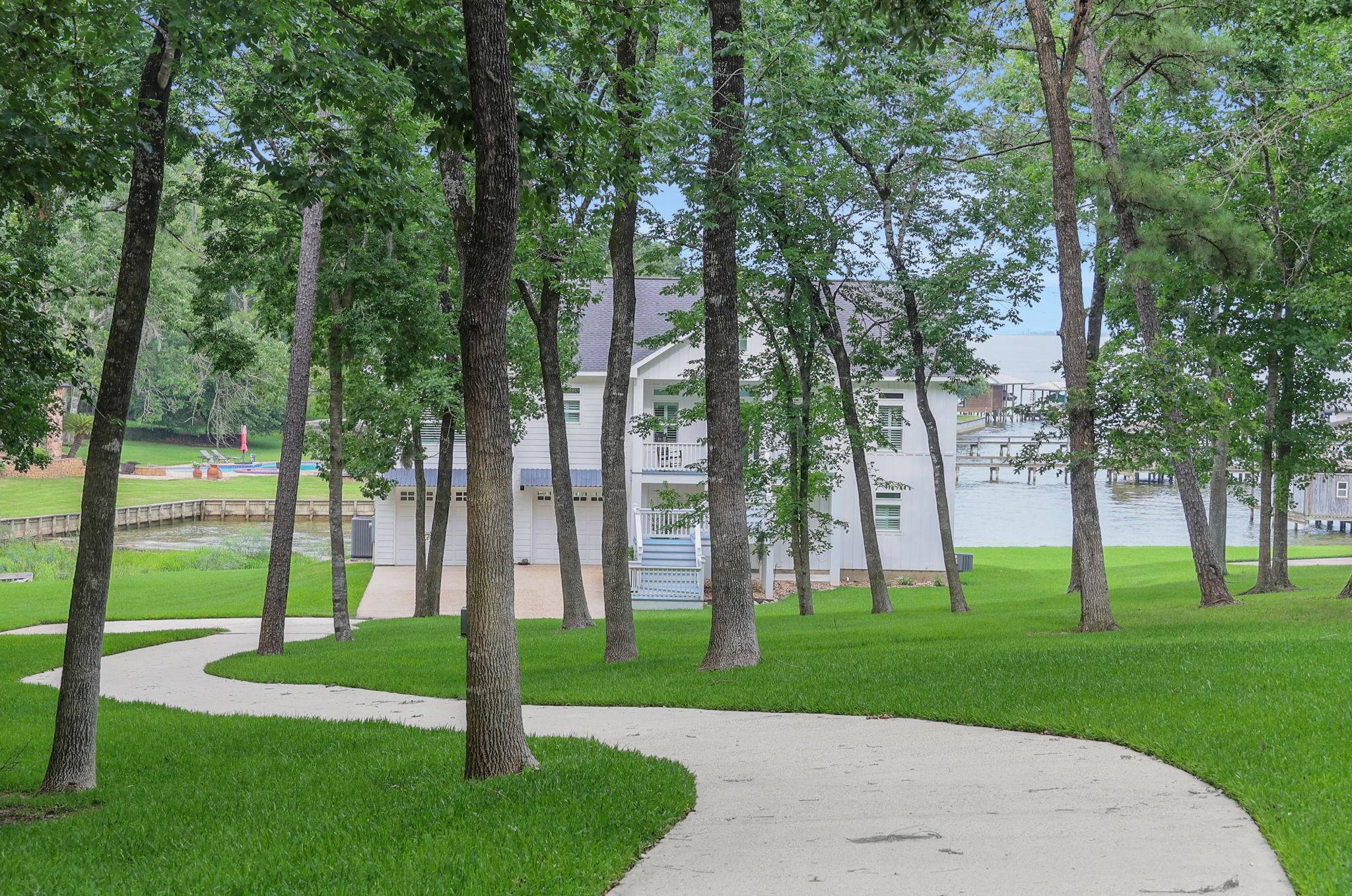 Image 4: As you make your way down the driveway, the home e