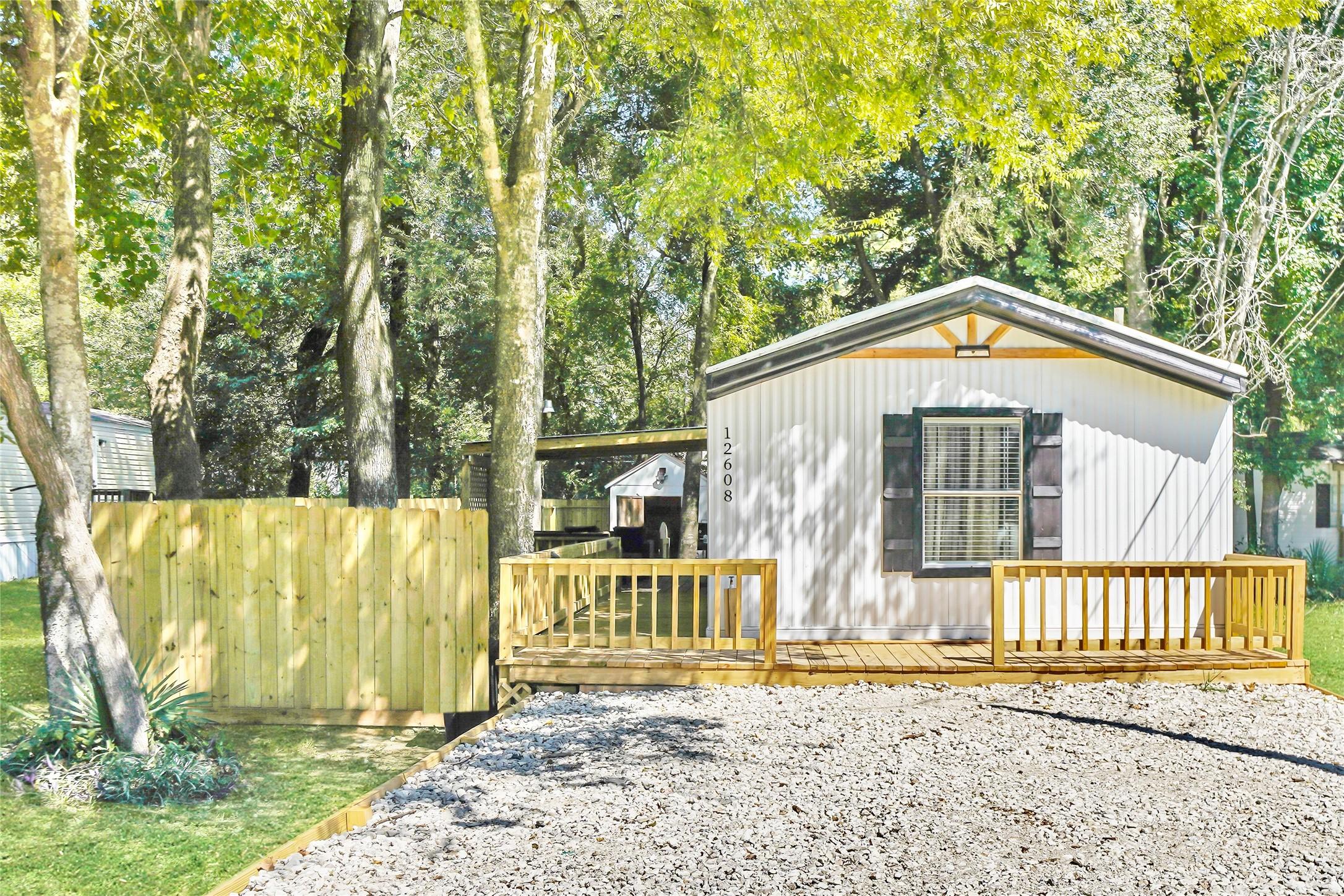 Image 1: Exterior front - mature trees, lake-community curb