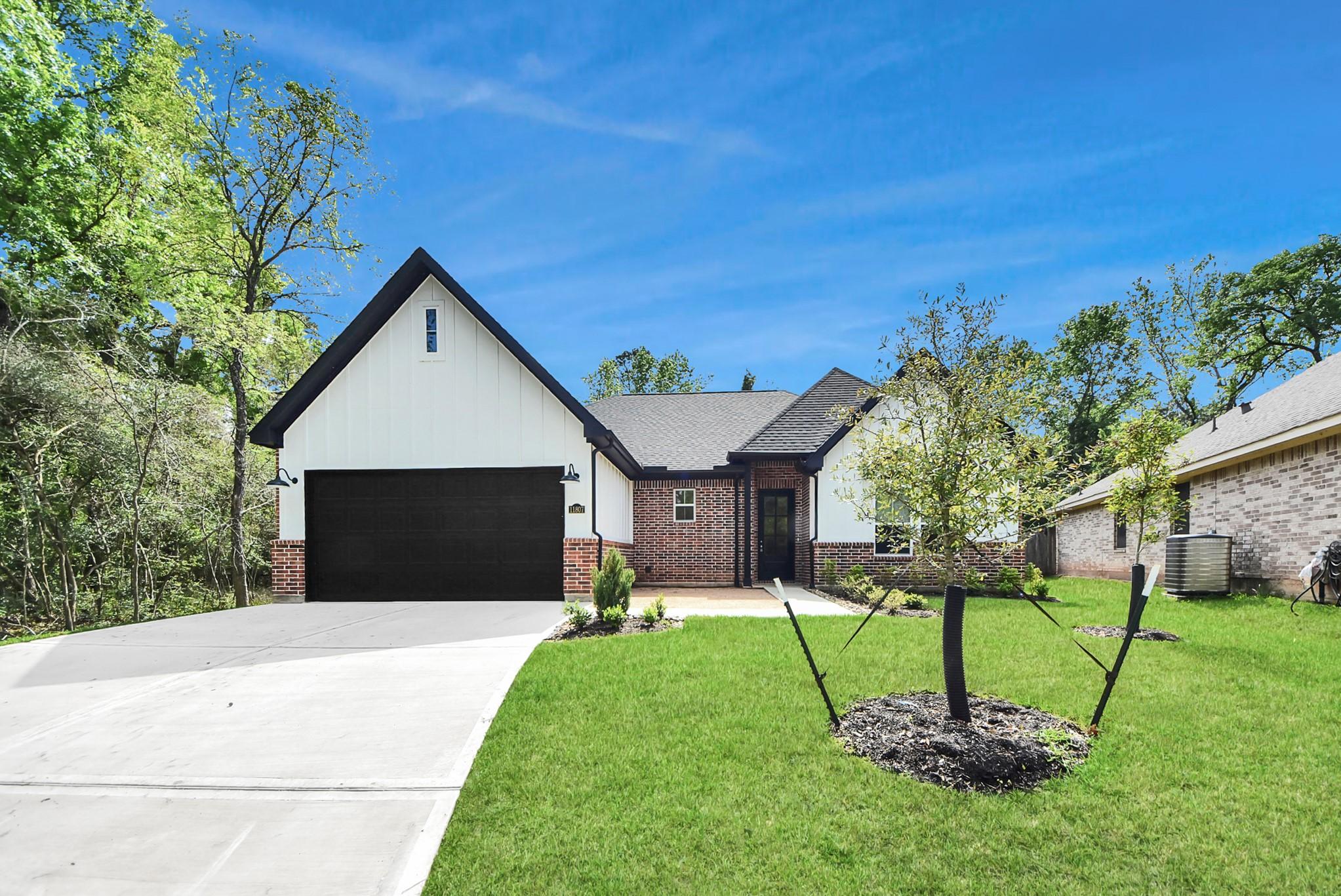 Image 2: Spacious driveway and front yard with well-maintai