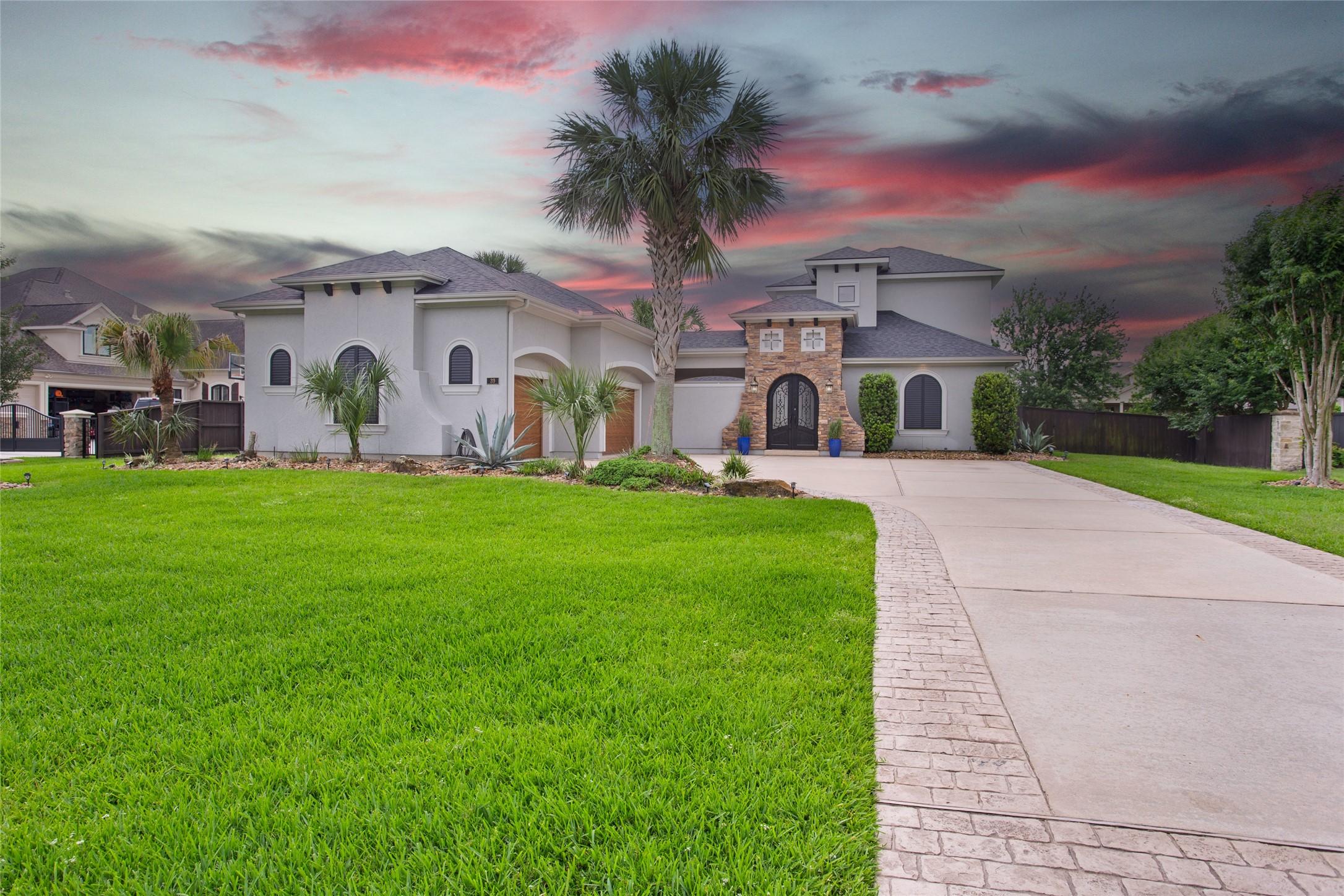 Image 2: This stunning home features elegant stone and stuc
