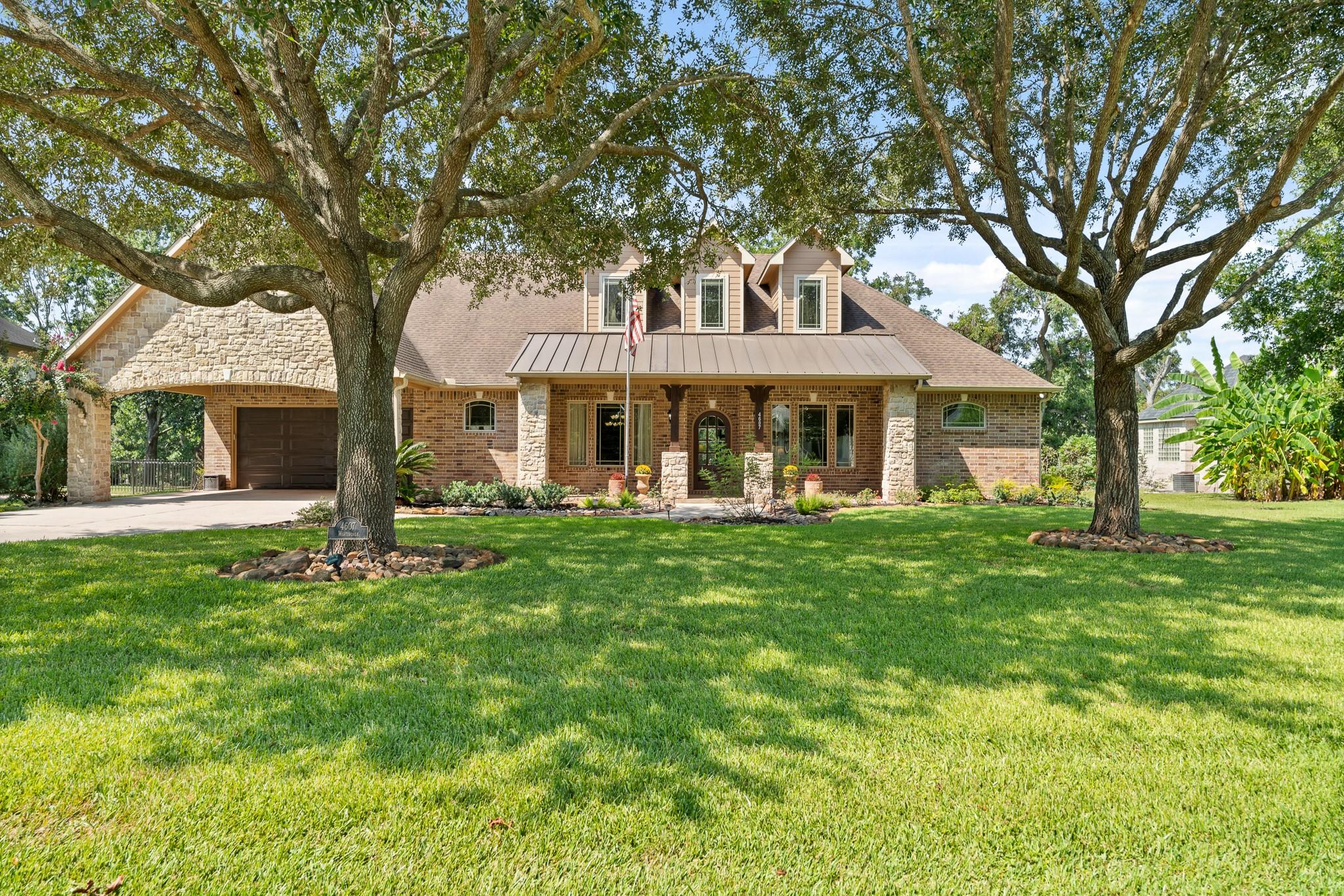 Image 1: Situated prominently on a generous &frac12; acre lot, thi