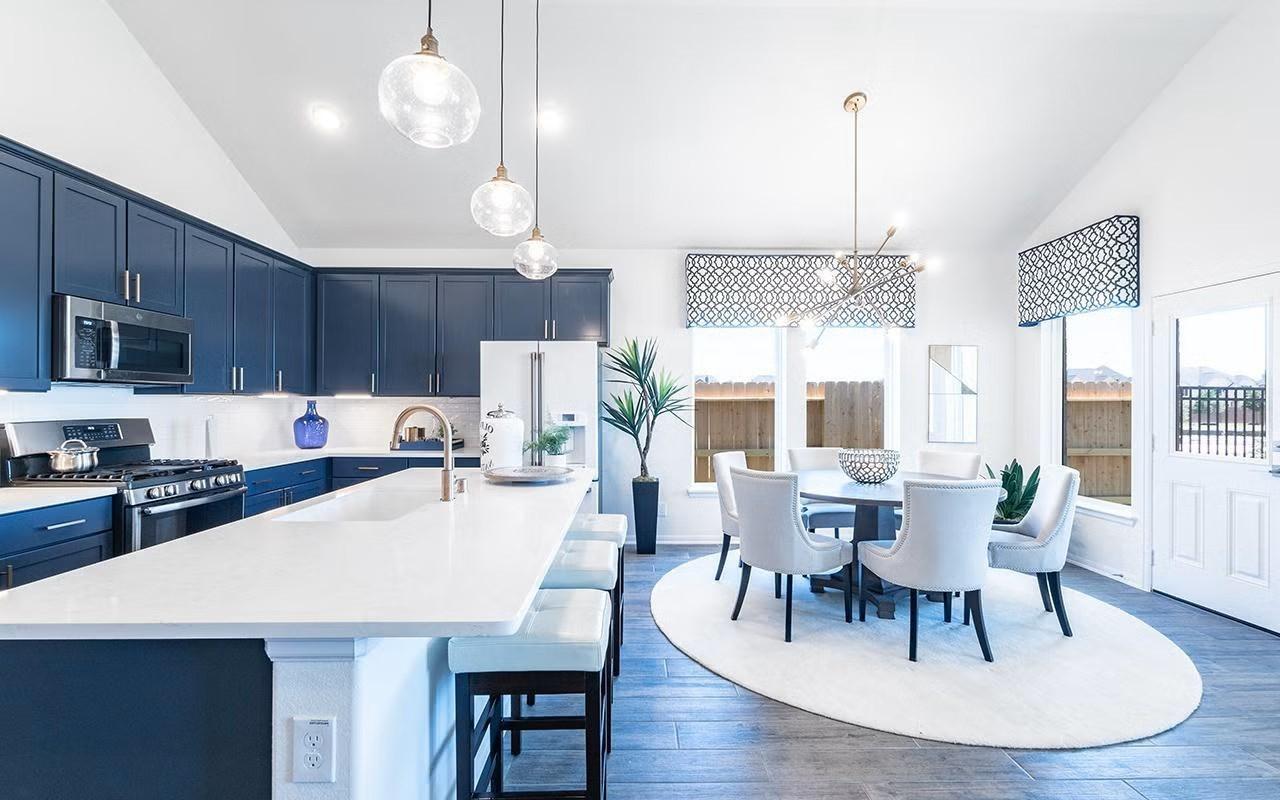 Image 4: Open concept kitchen and dining area designed for