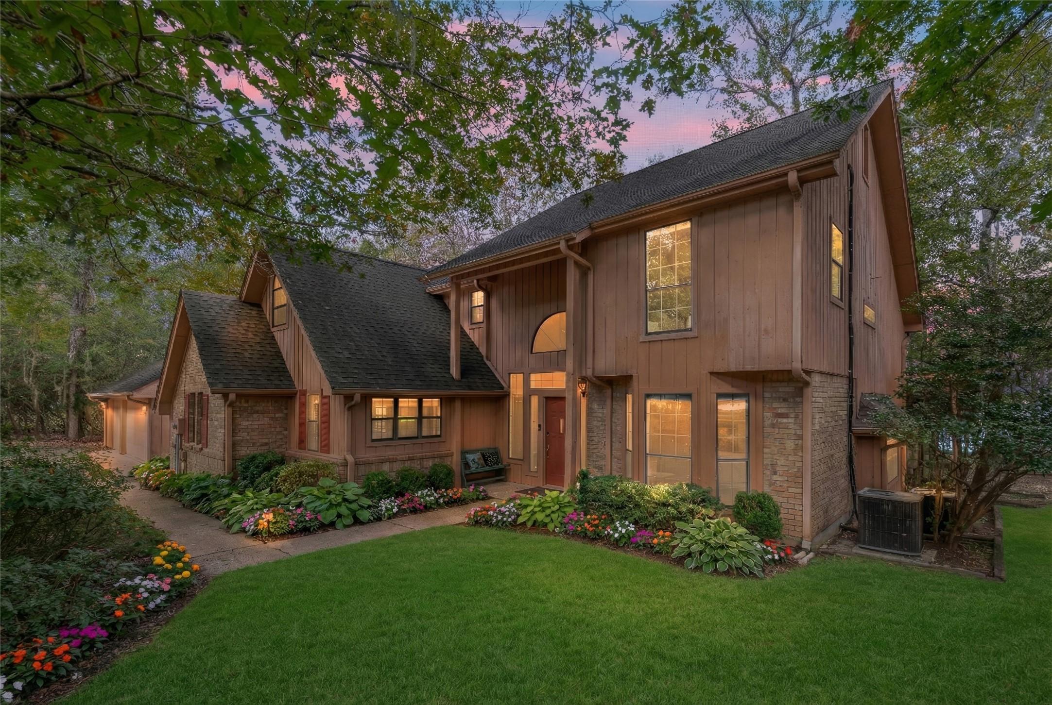 Image 3: This charming two-story home features a warm woode