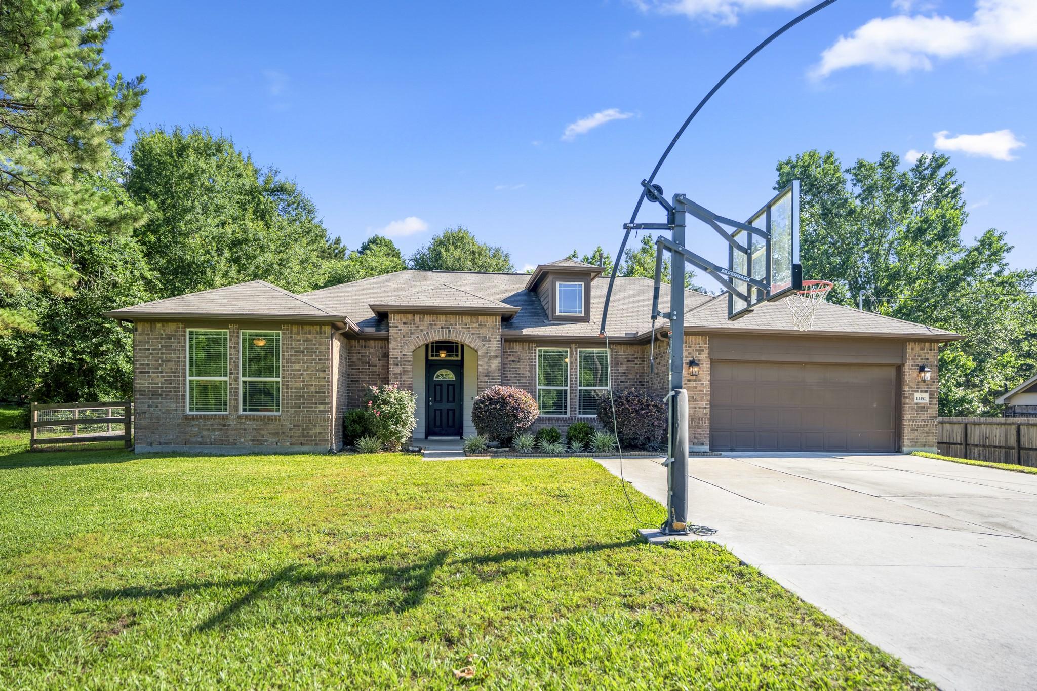 Image 2: Tucked among the trees on 1.085 acres in the gated