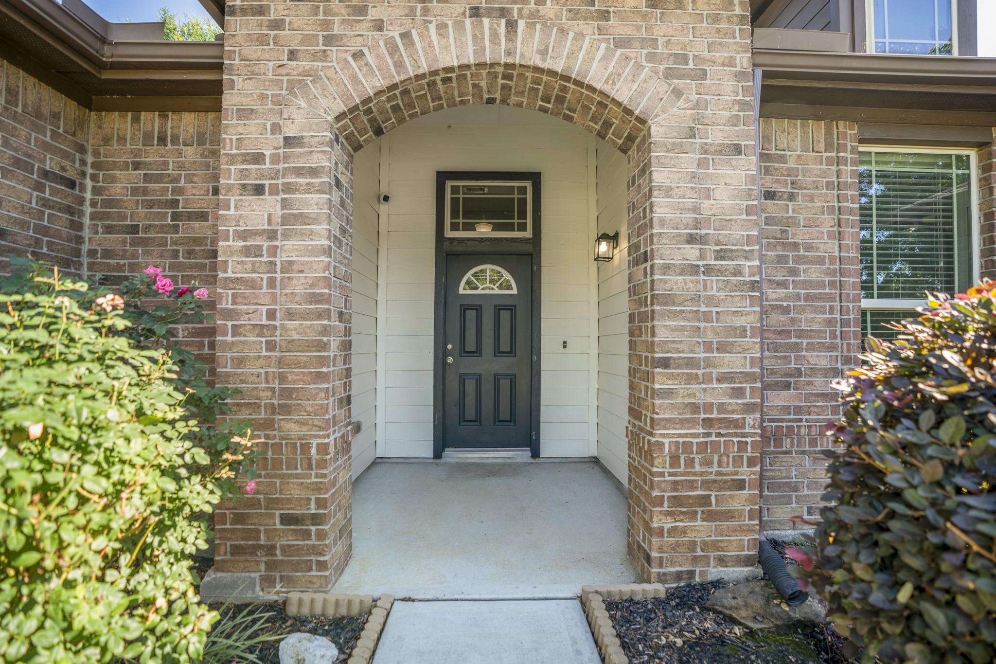 Image 4: Brick arch detailing and the covered front porch c