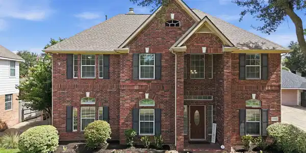 Image 3: Stately brick home with charming gables and elegan
