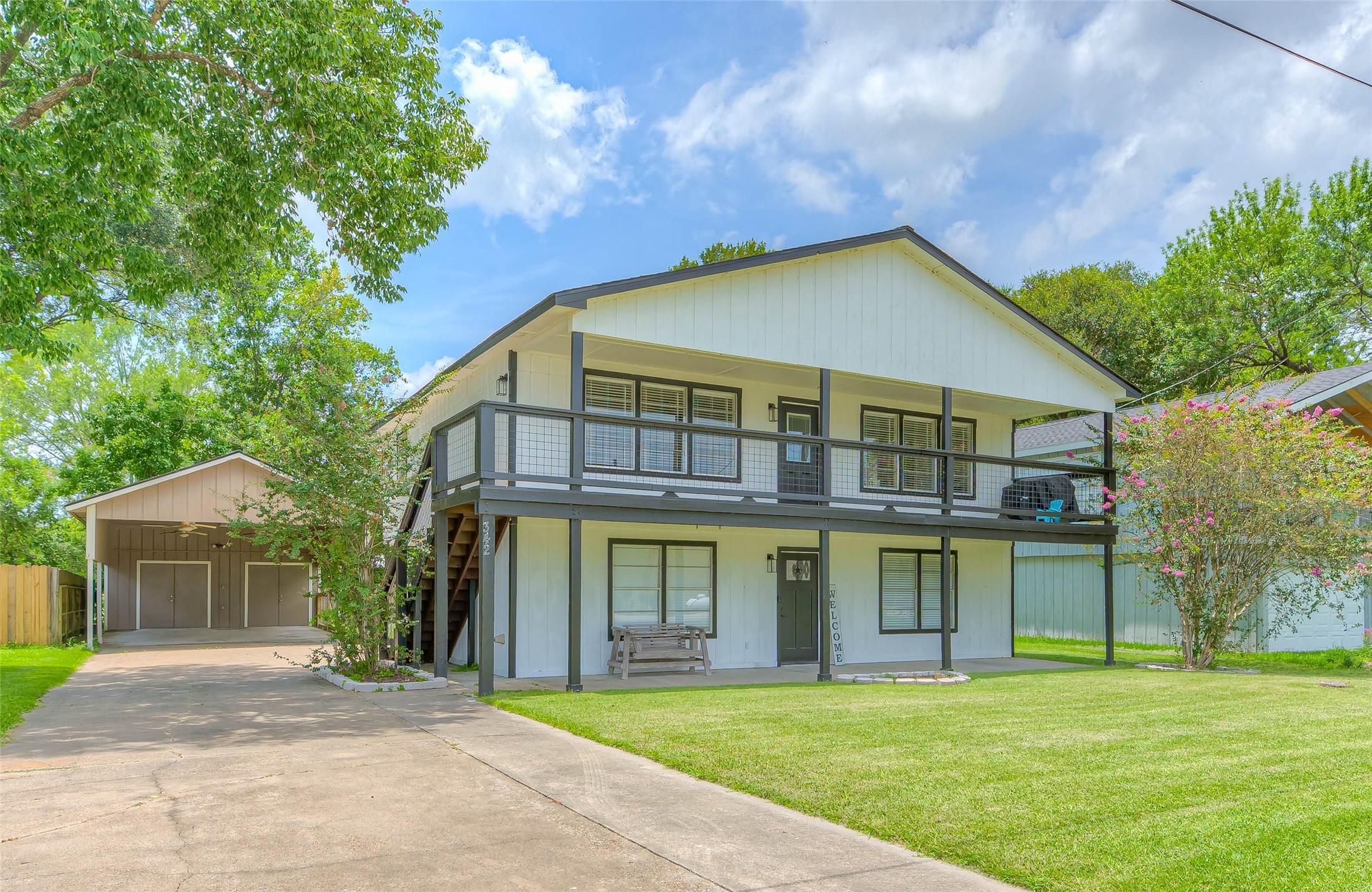 Image 2: This two-story home features dual stairwells (indo