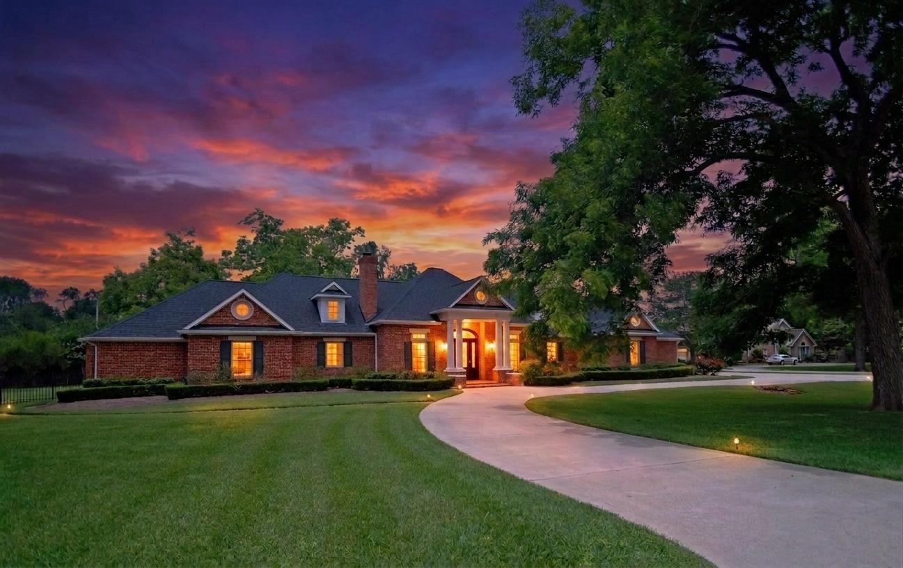 Image 2: Charming brick home with a spacious front yard and