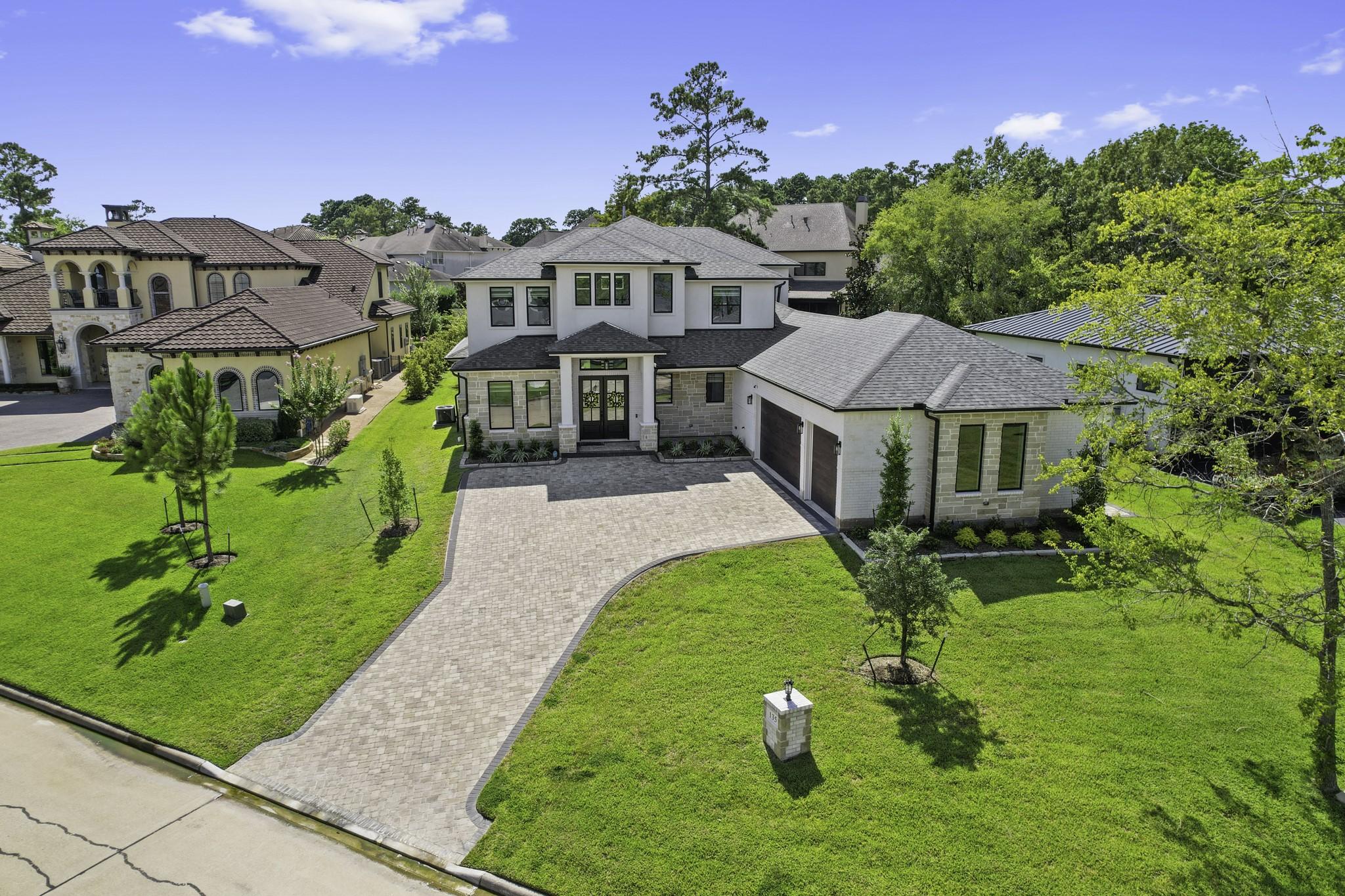 Image 2: Extended paved driveway leading to 3 car garage