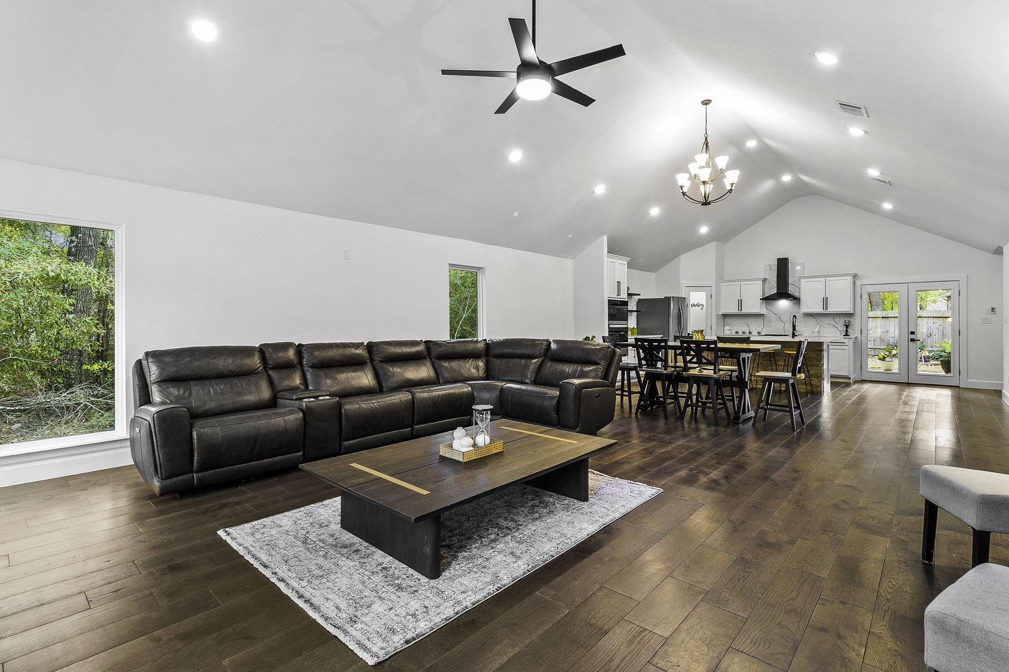 Image 3: This spacious open-concept living area features hi