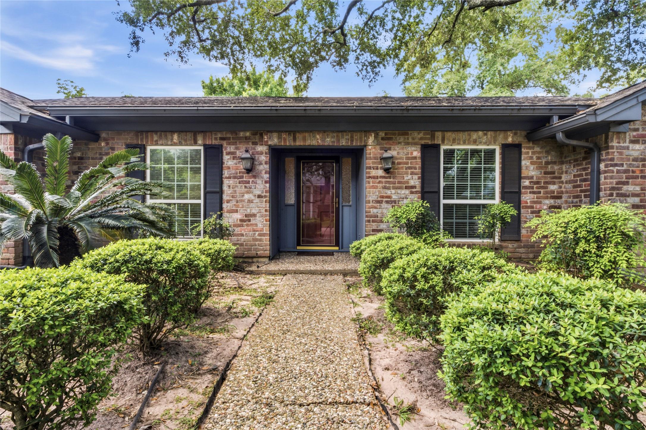 Image 3: Charming curb appeal with mature landscaping and a