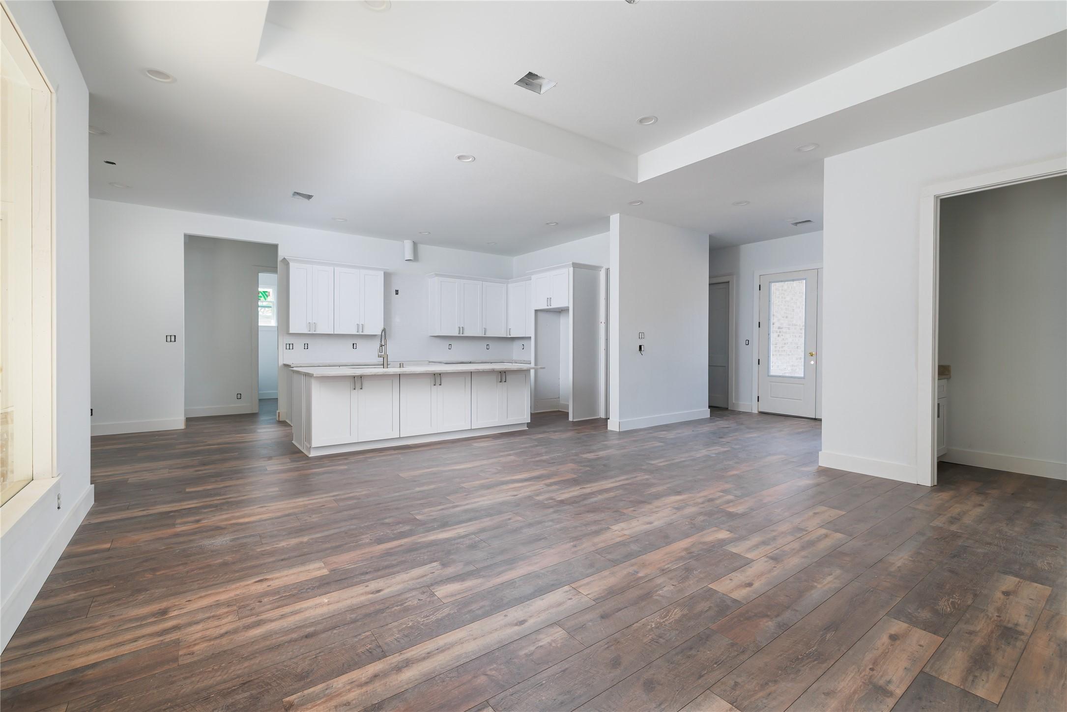 Image 3: Open-concept living and dining area with a dramati