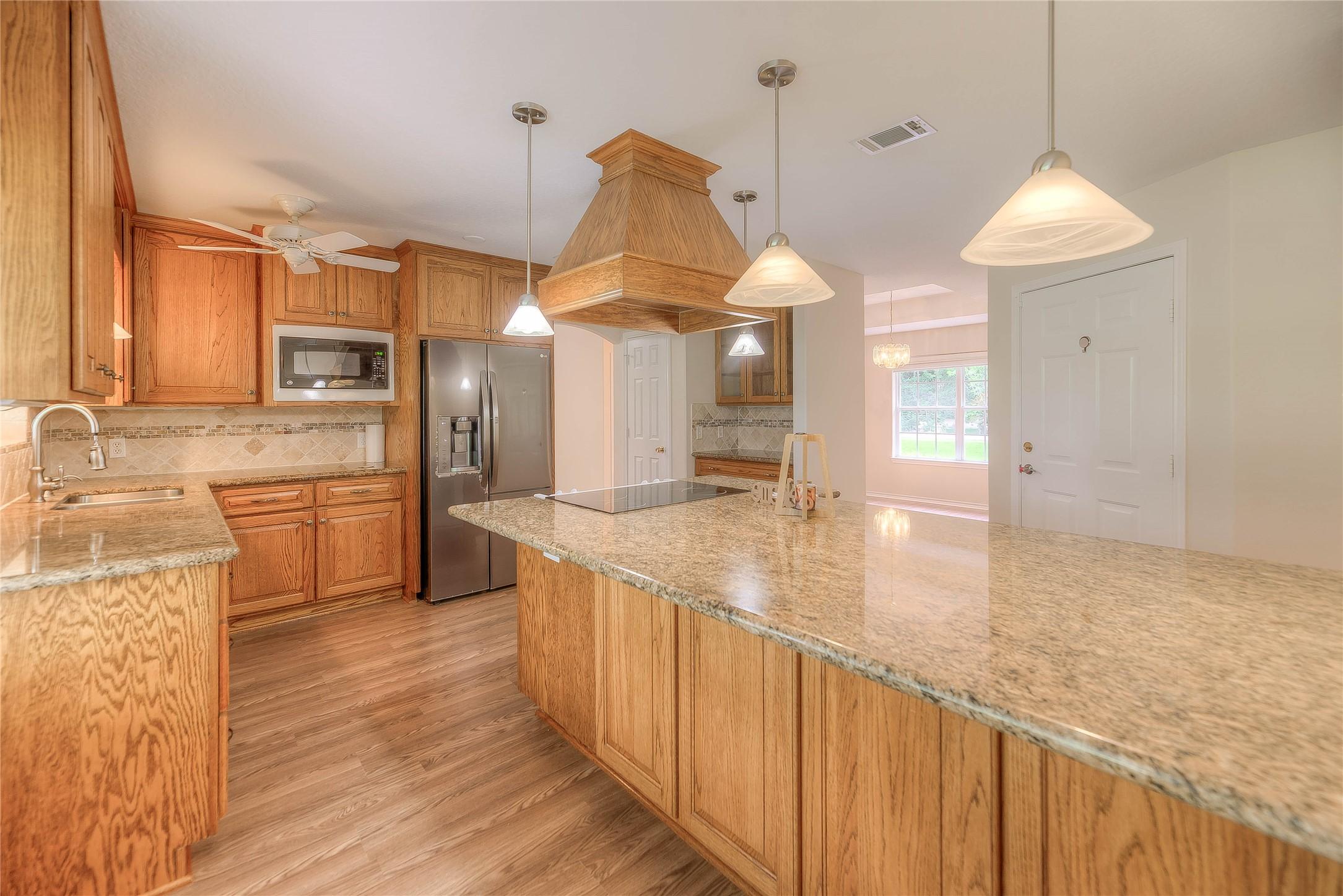 Image 4: Beautiful custom wood cabinets topped with luxurio