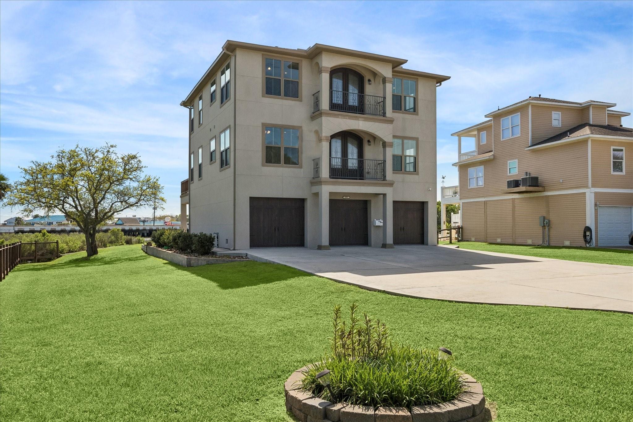 Image 2: The property includes a large side yard that overl