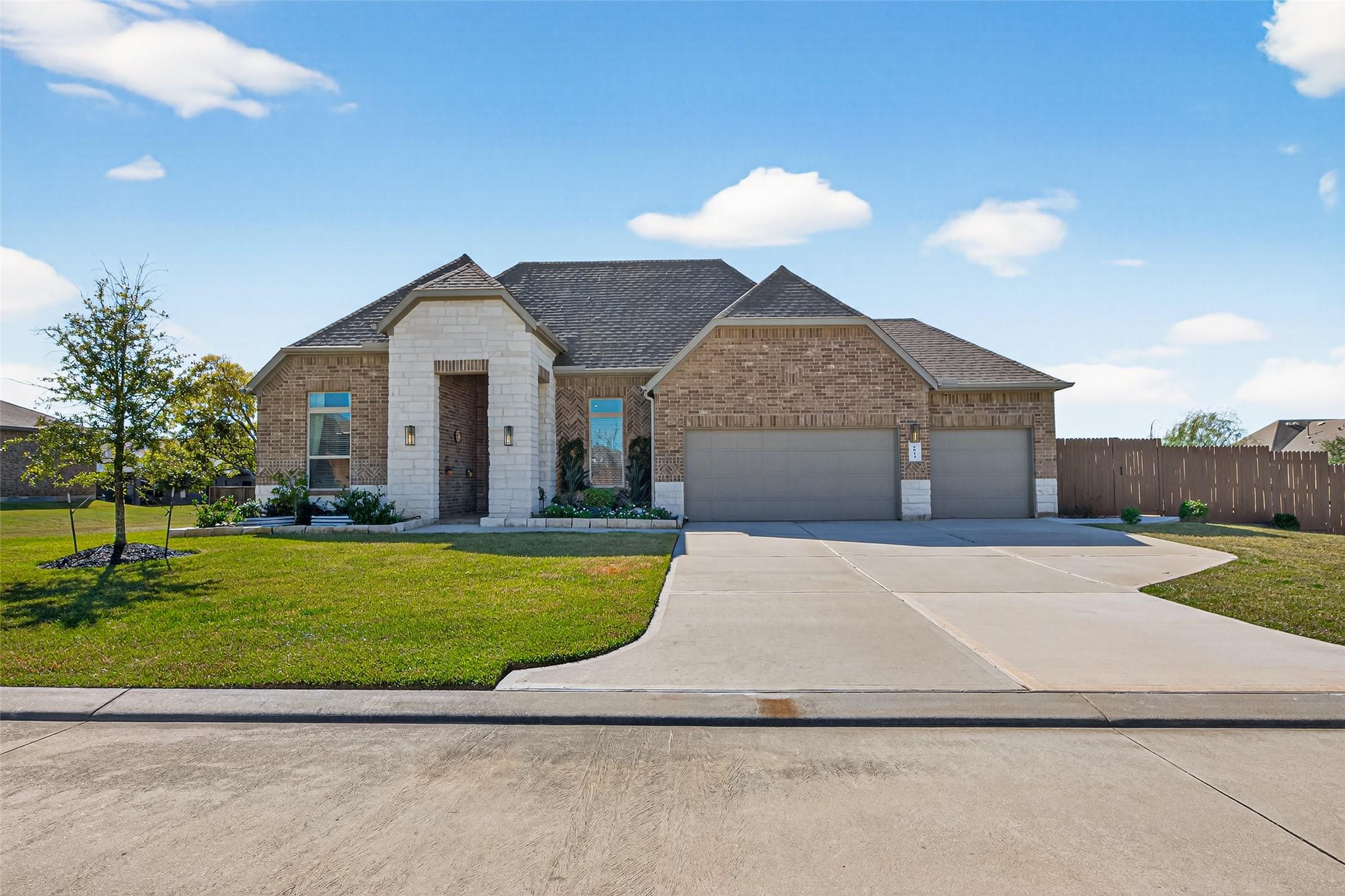 Image 1: Spacious driveway and an inviting entrance with st
