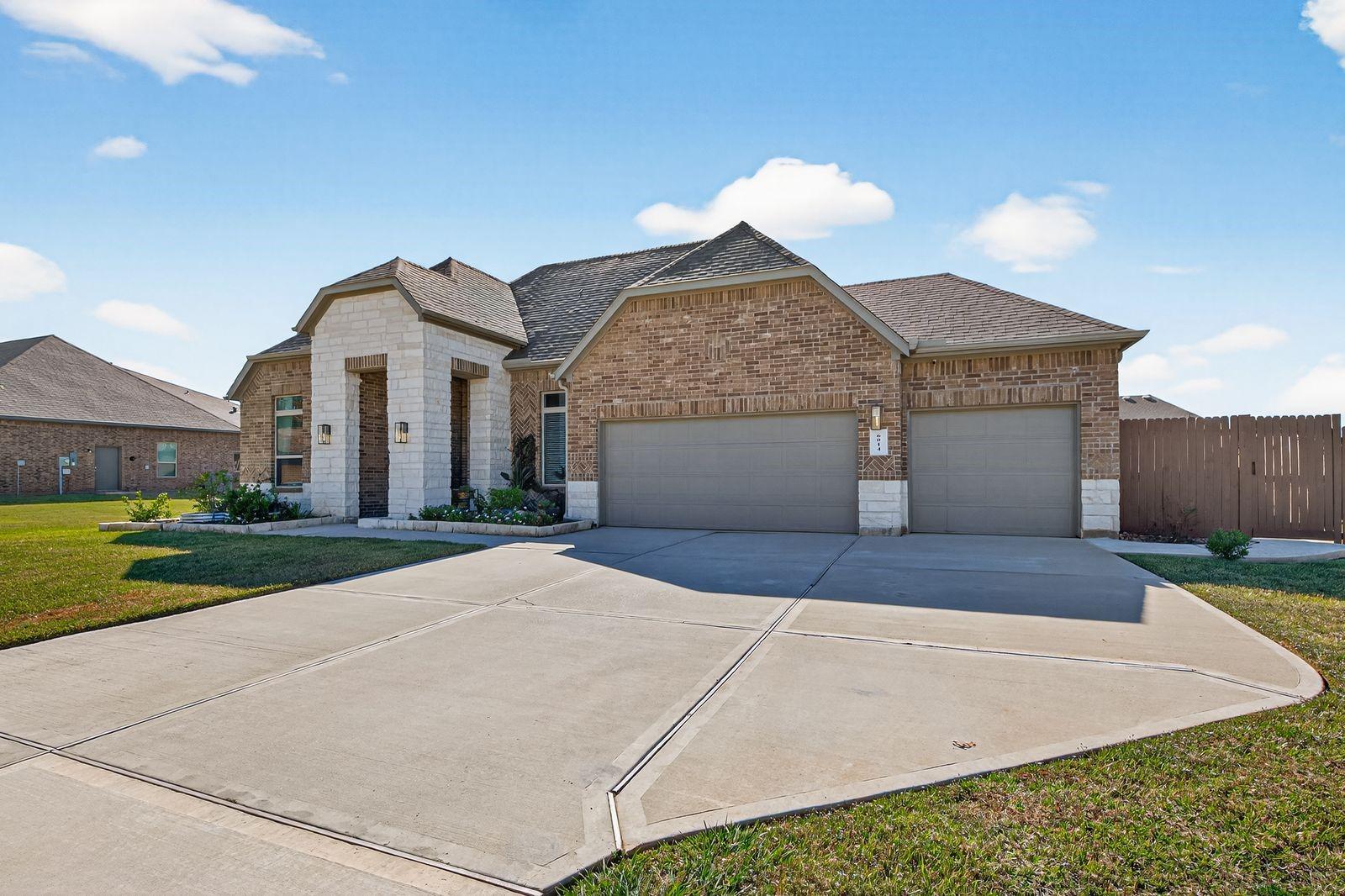Image 4: This home features a modern brick exterior with a