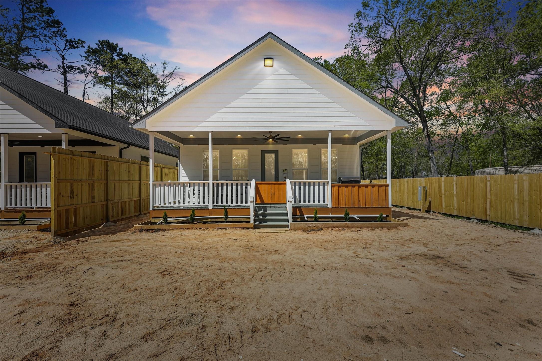 Image 3: This charming home features a modern, white exteri
