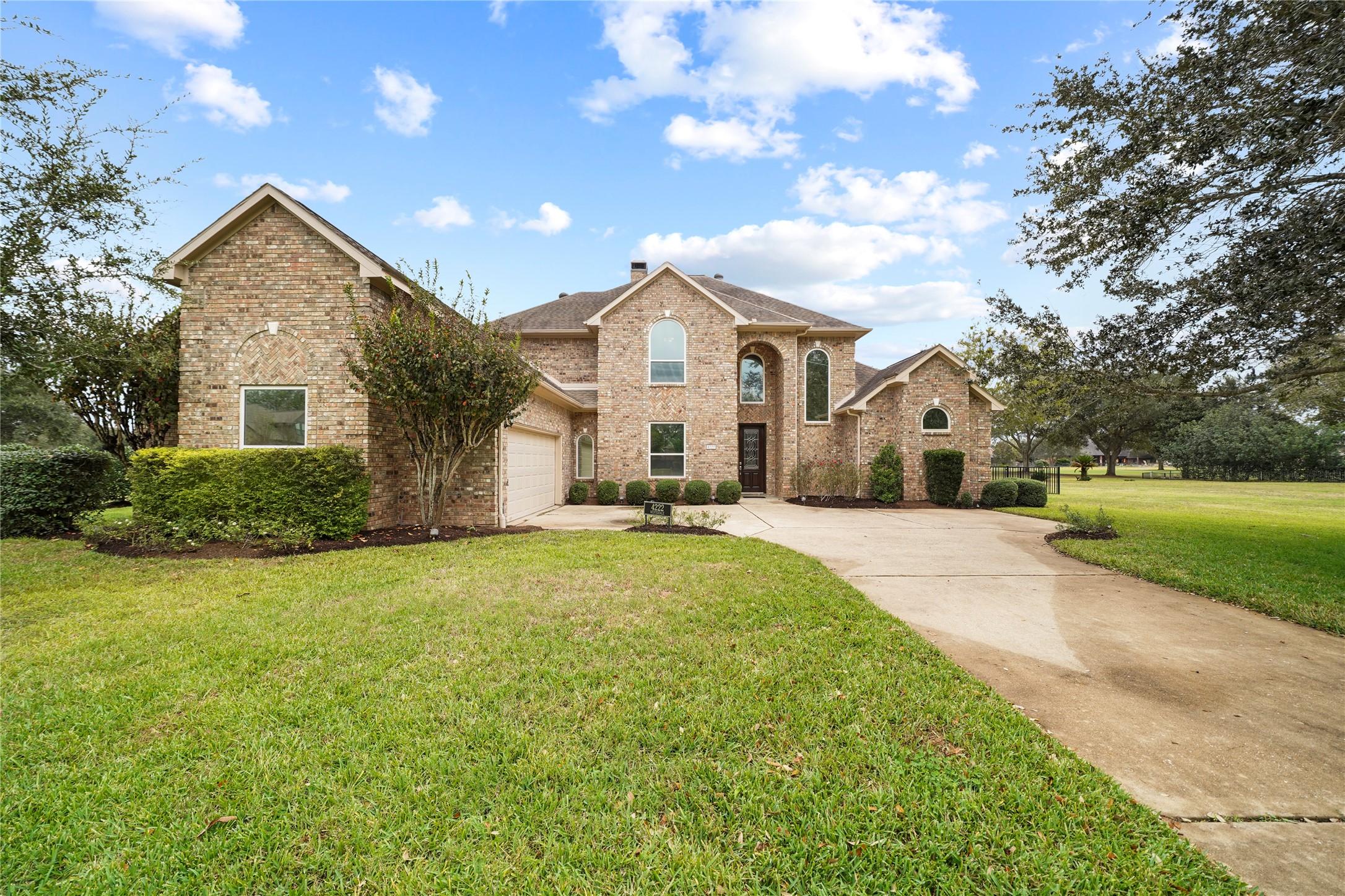 Image 2: This impeccably maintained two-story brick home en
