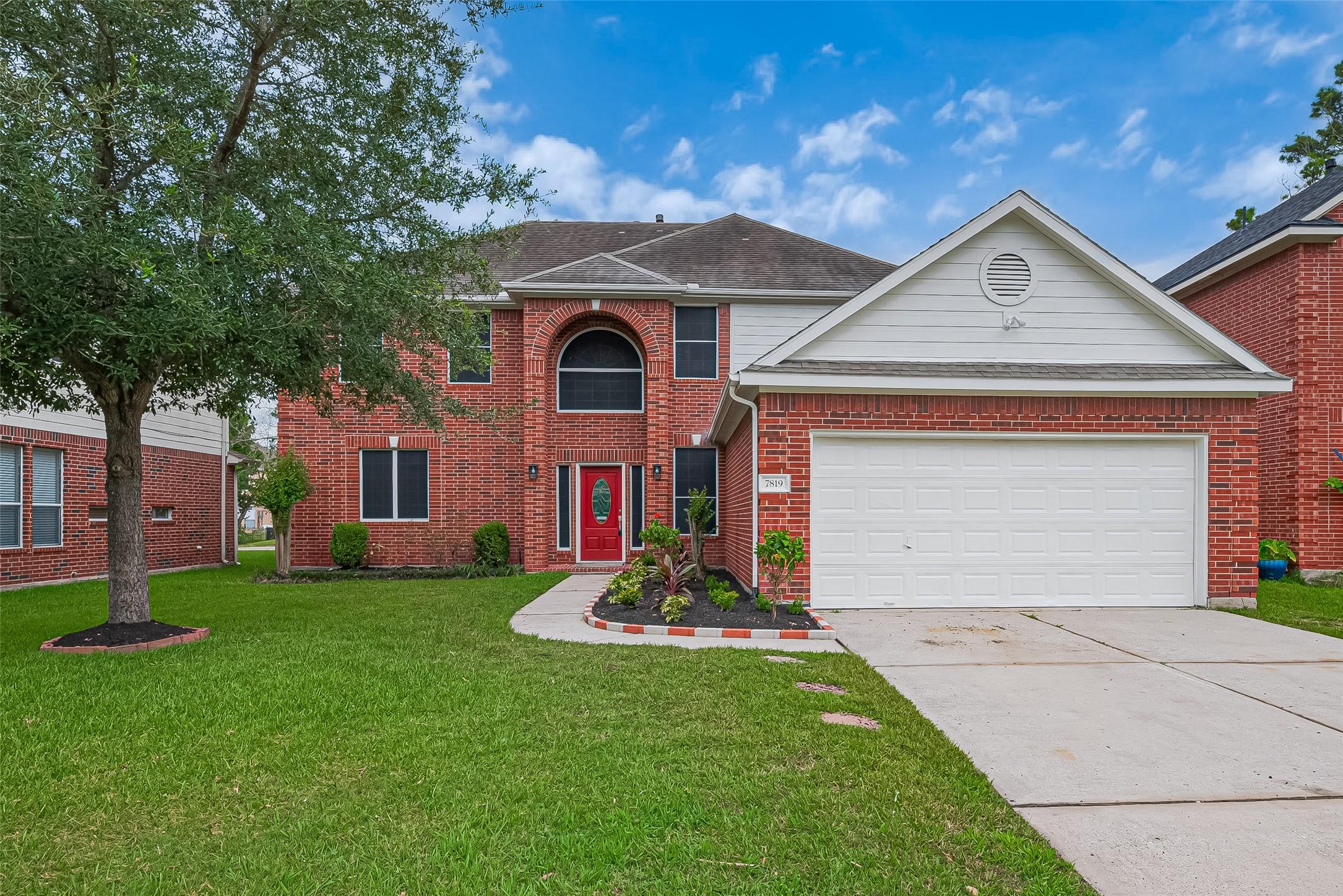 Image 1: Two-story home with a beautifully landscaped front