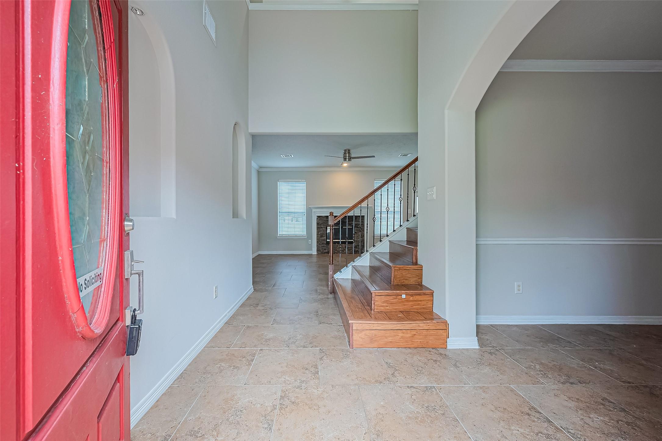 Image 4: Entryway door, tiled flooring, and a view of the s