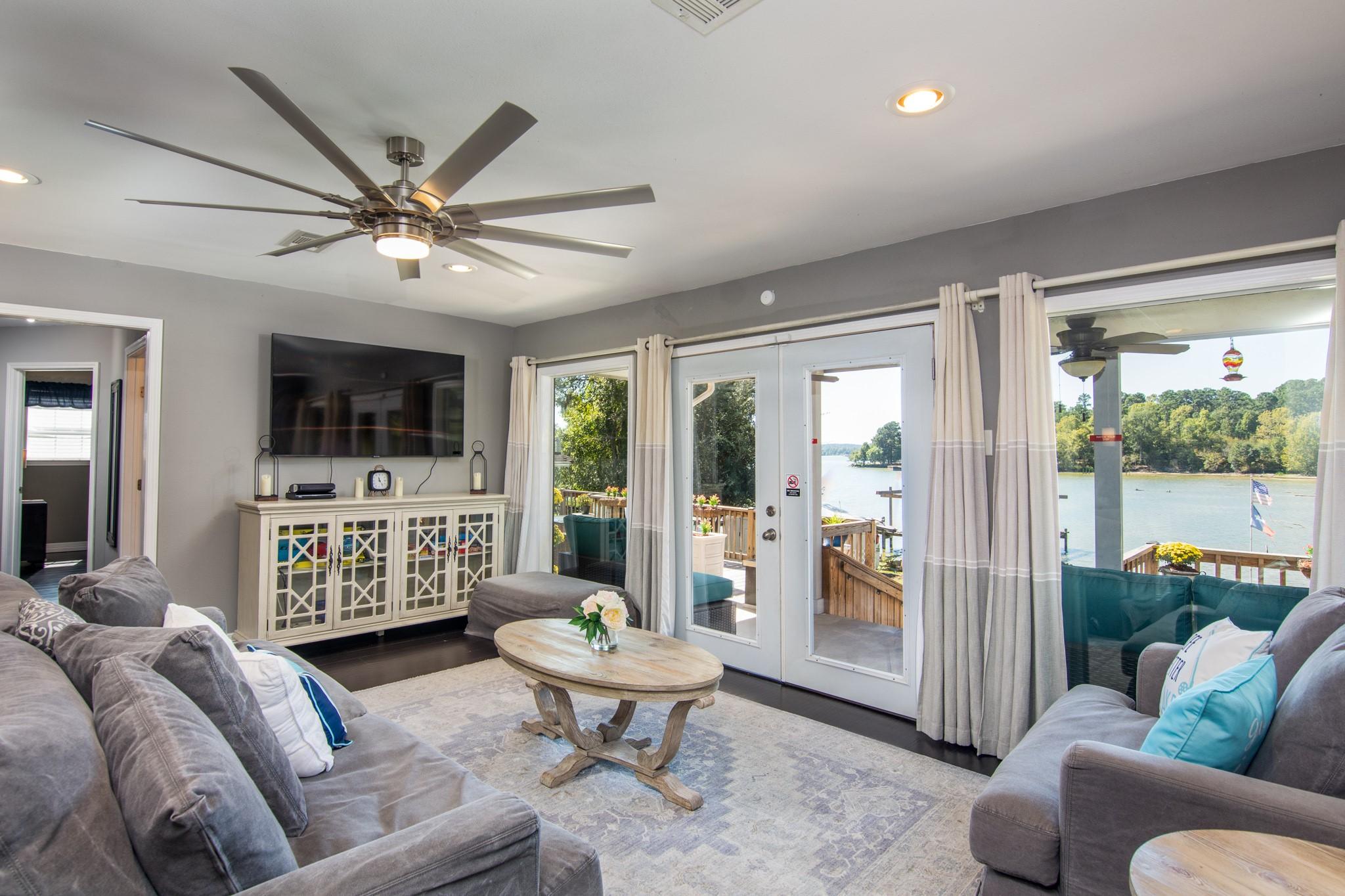 Image 3: Welcoming living room with large windows and glass