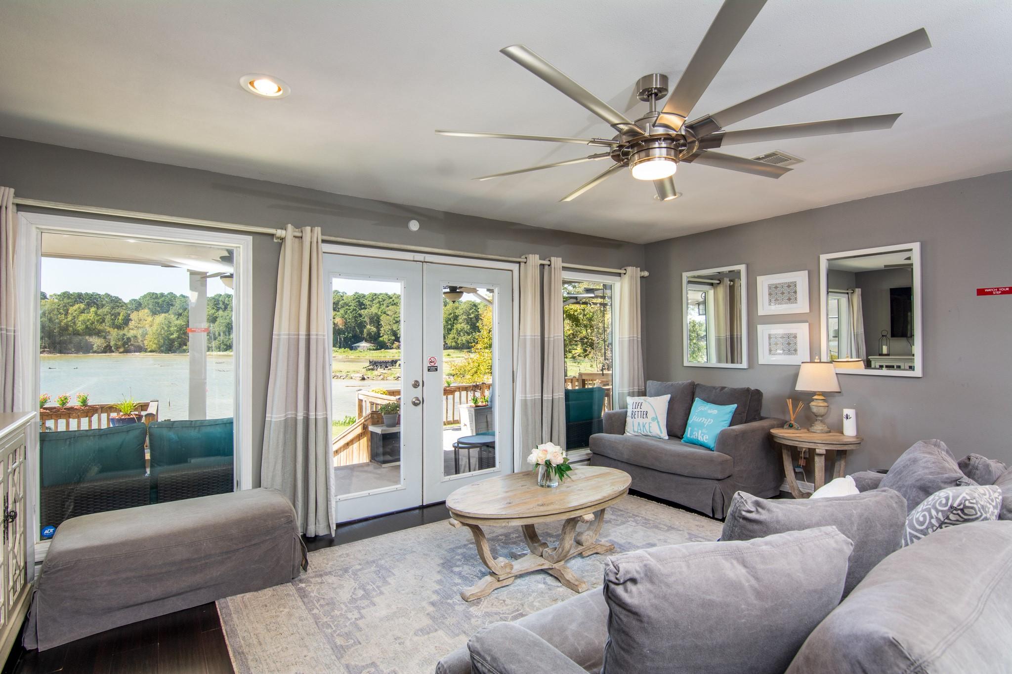Image 4: Light-filled living area with wide windows and dir