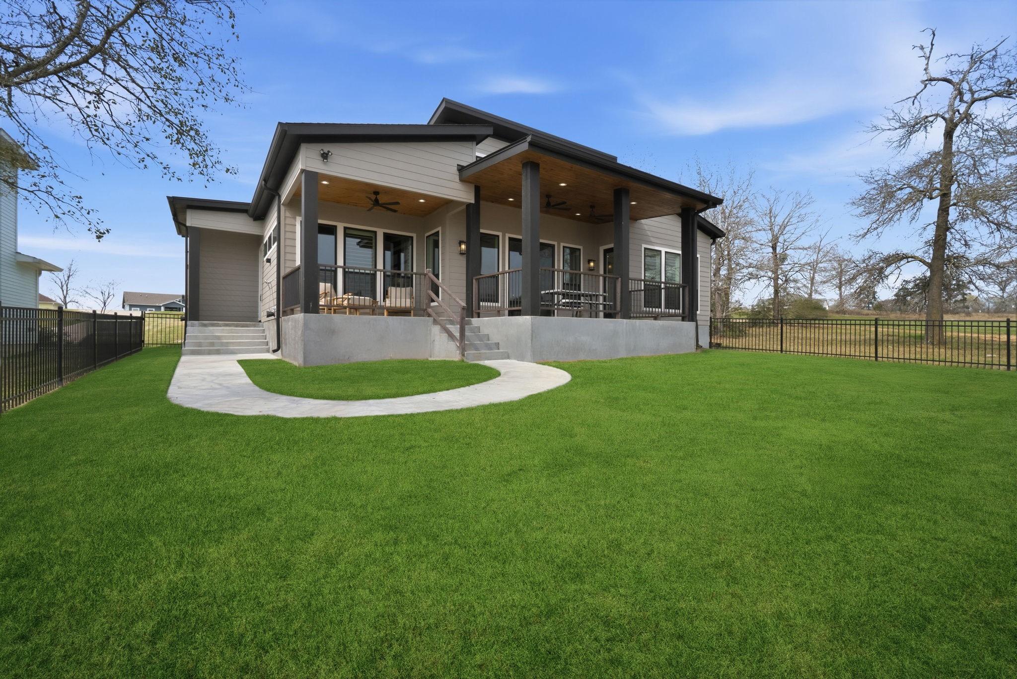 Image 2: Fenced back yard with double gates leading out to