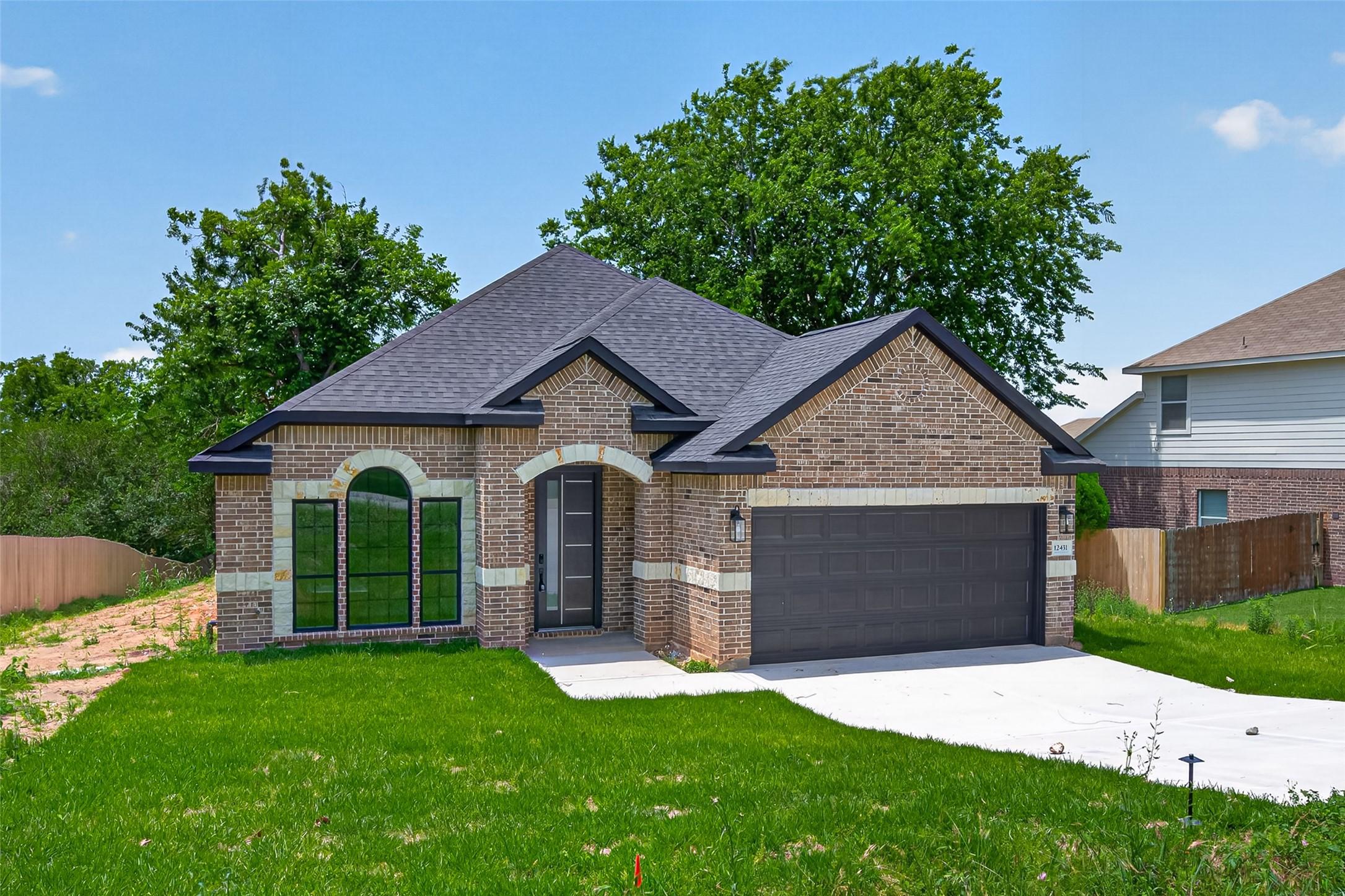 Image 3: This charming home features a brick exterior with