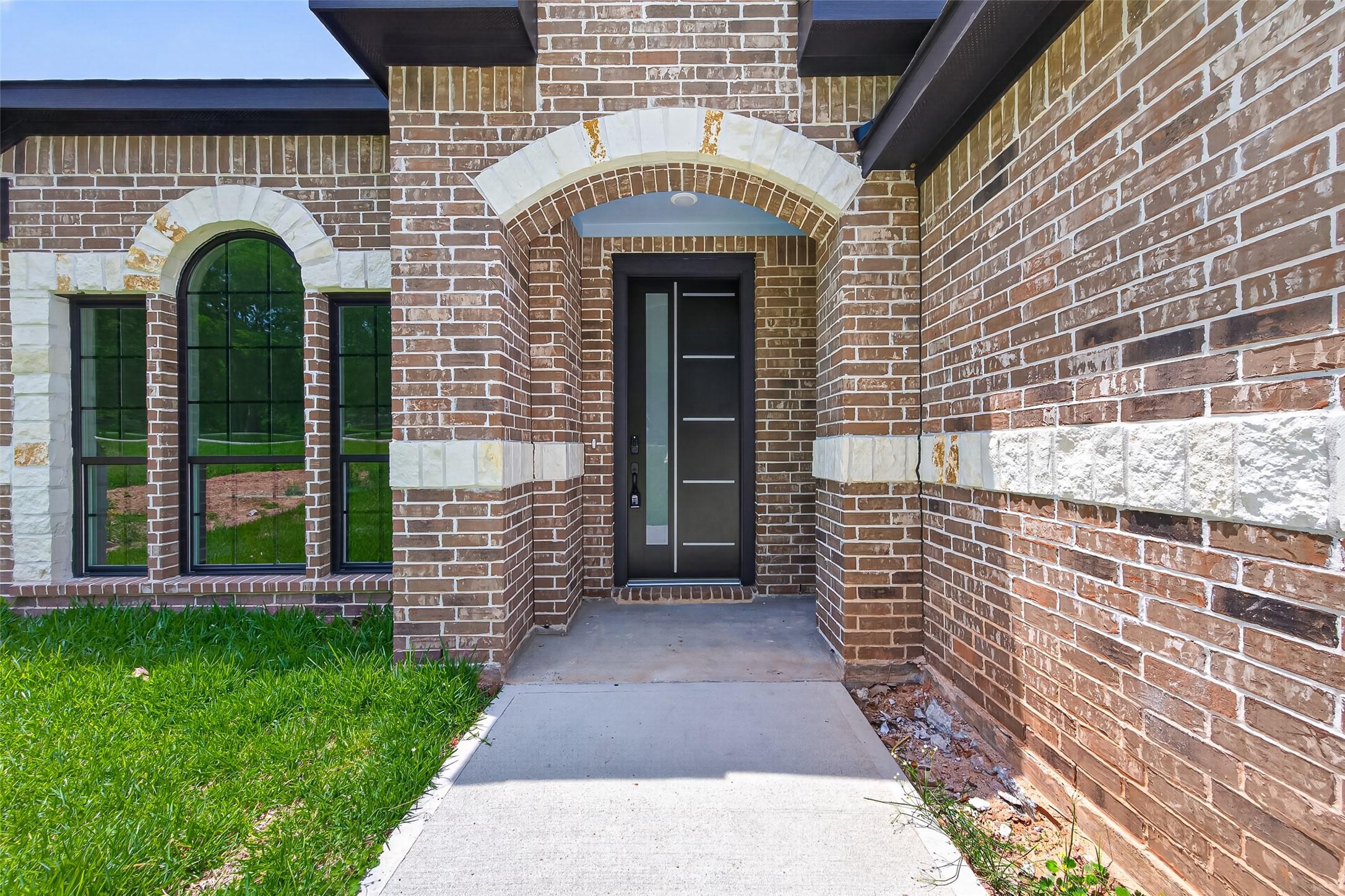 Image 4: This charming home features a brick exterior with