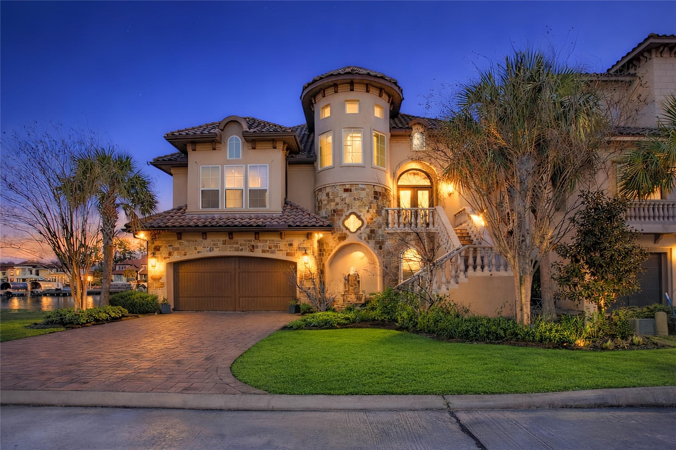 Image 2: This stunning home features a Mediterranean-style