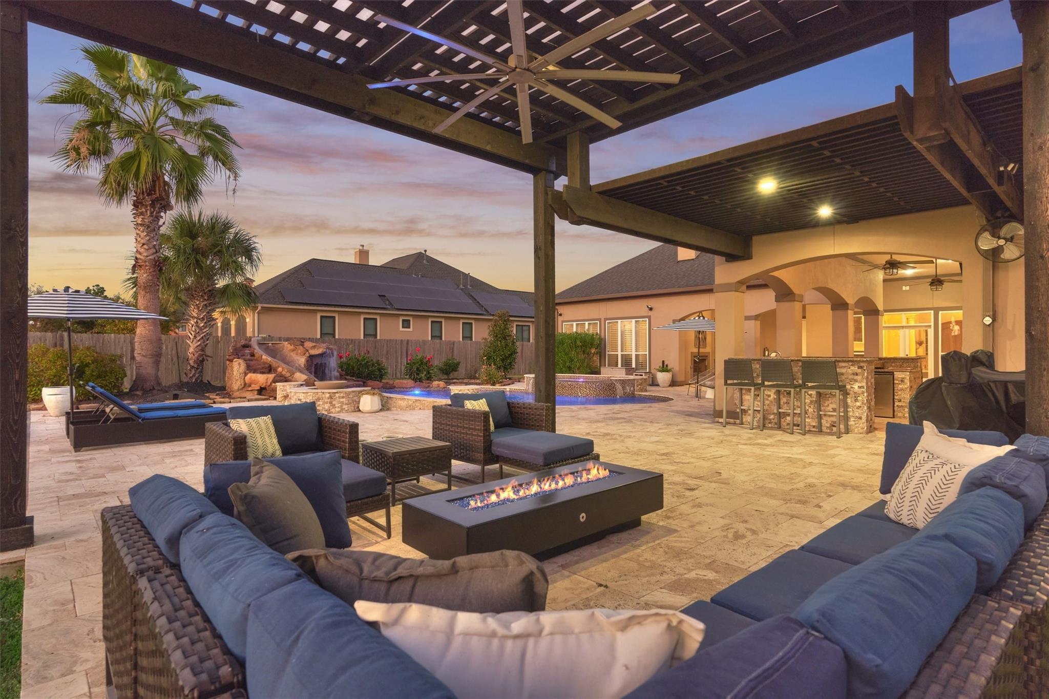 Image 4: A beautiful pergola adds another gathering space t