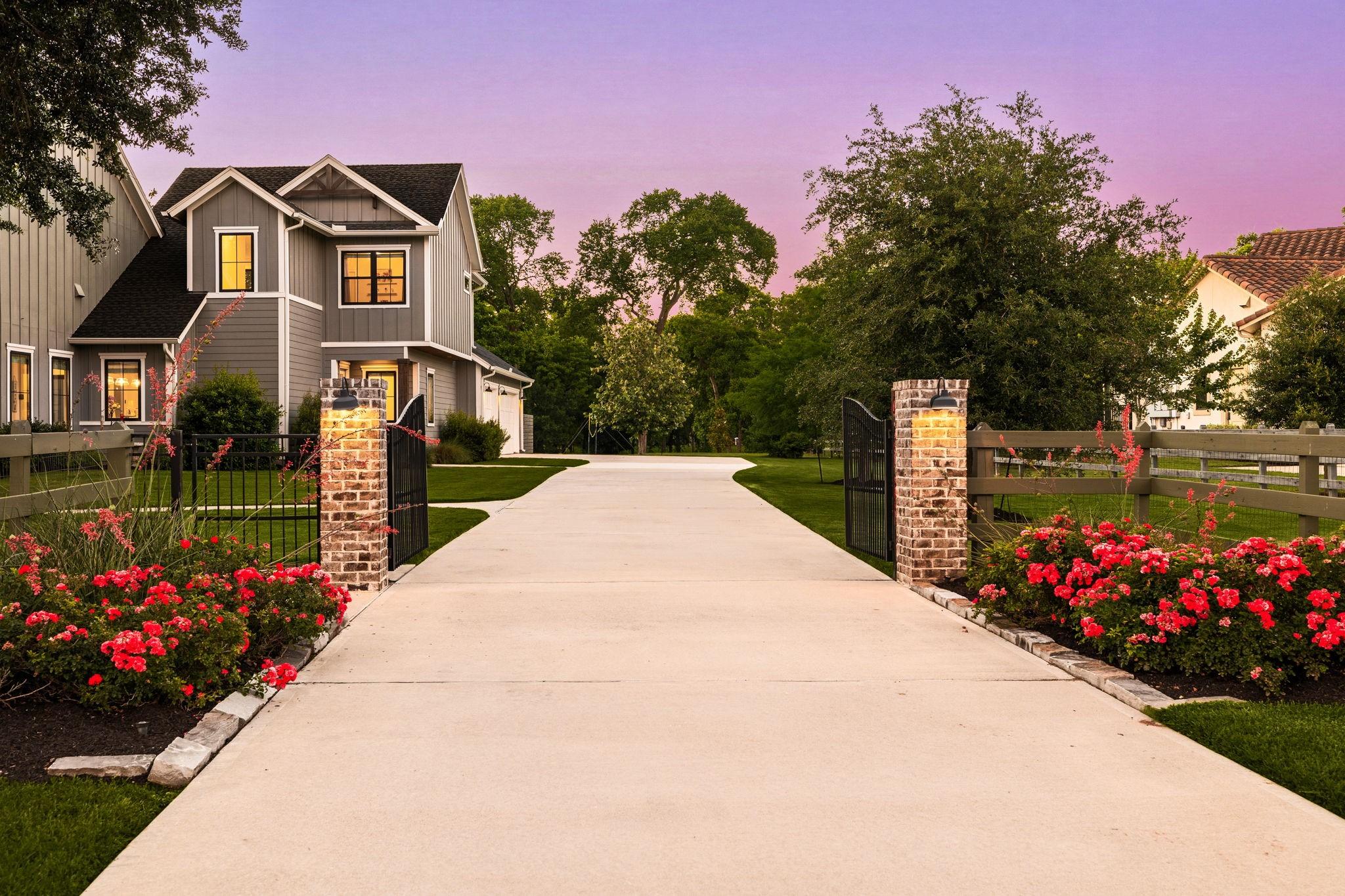 Image 4: Private gated driveway with elegant landscaping an