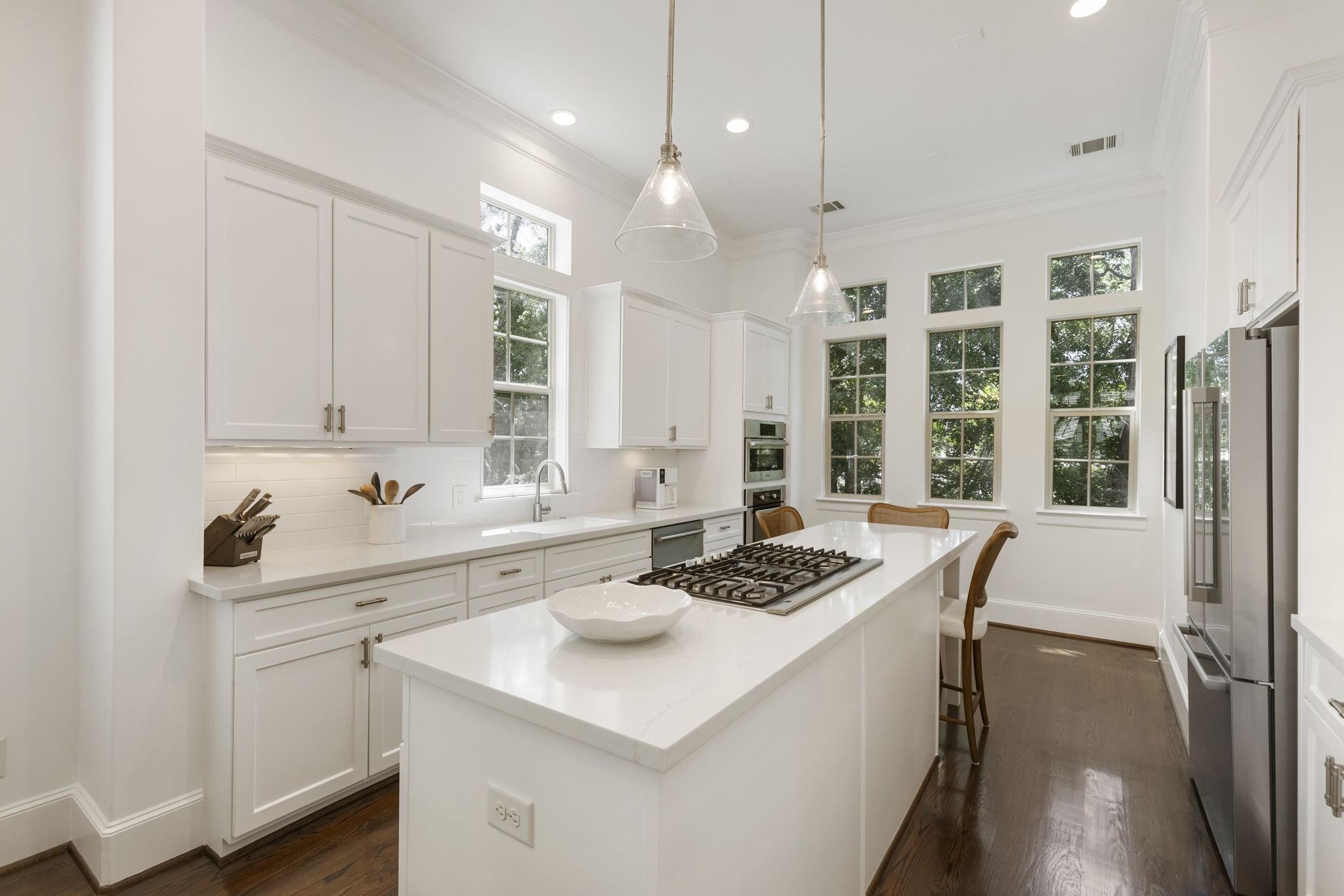 Image 3: Updated Kitchen featuring an extended quartz islan