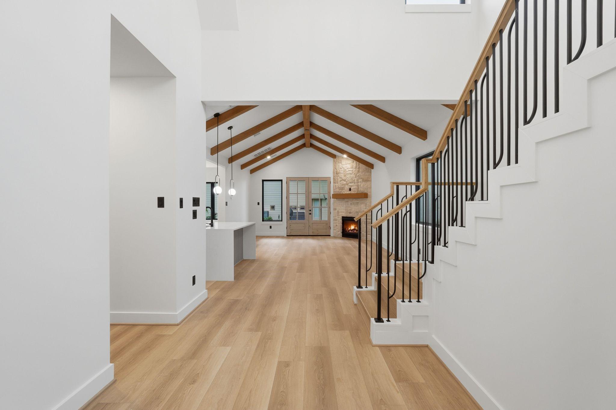 Image 3: The entry opens with cathedral ceilings, faux ceda