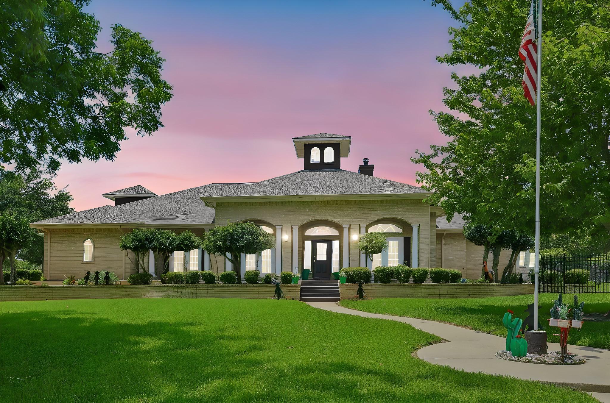 Image 3: A stunning single-story brick home with a grand en