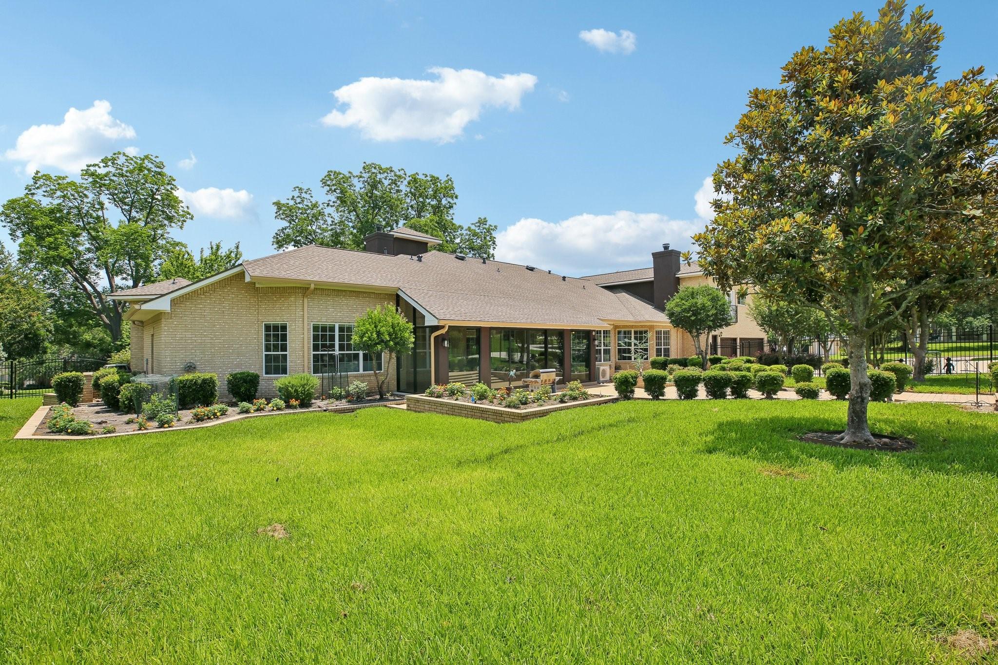 Image 4: The rear and side yard showcase meticulously maint