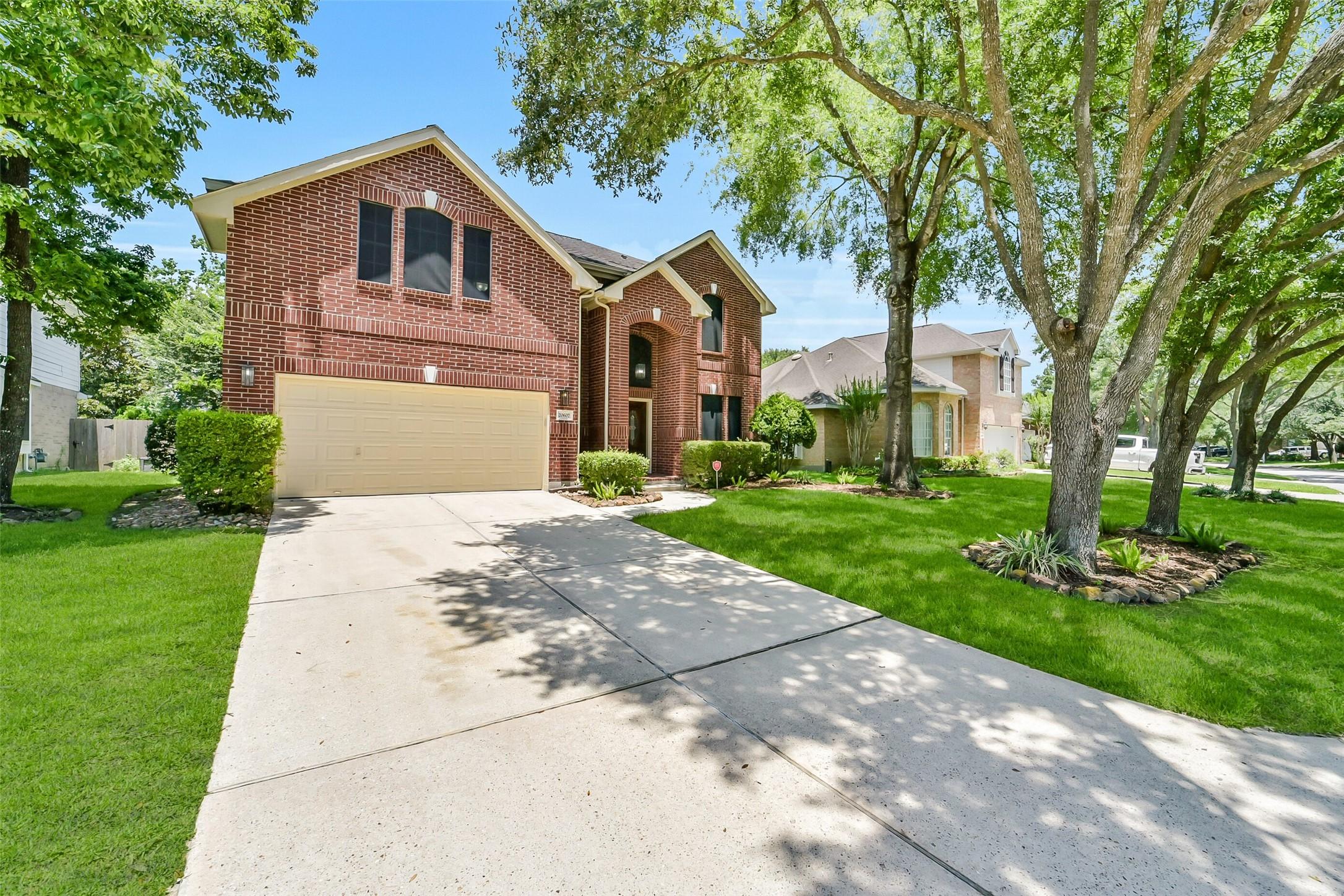 Image 1: Handsome brick home situated on tree lined street