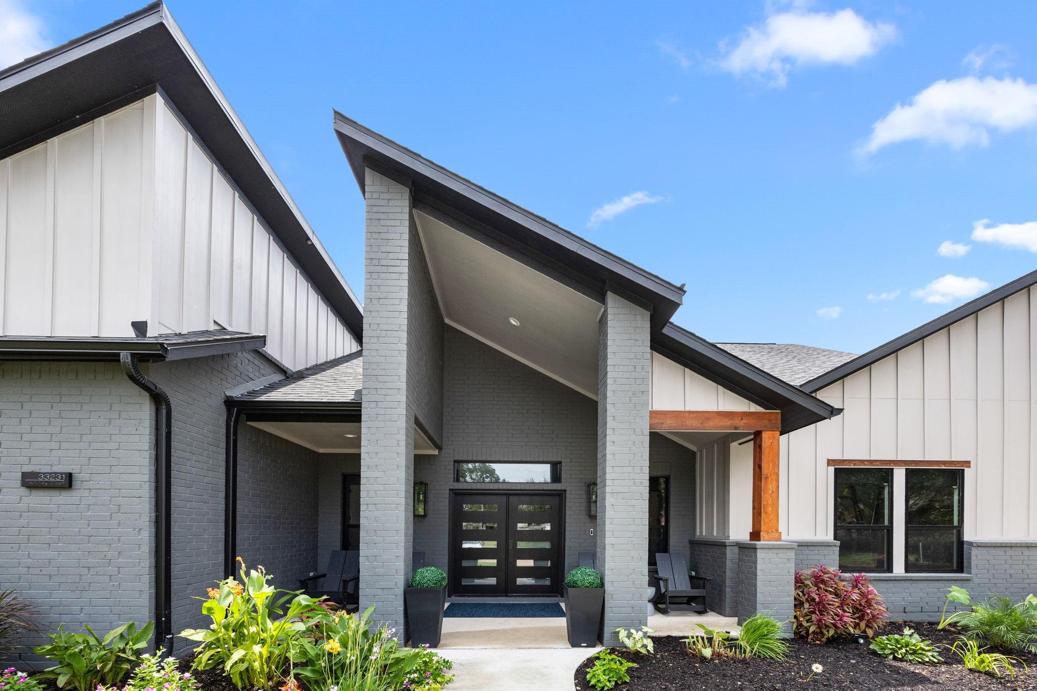 Image 2: Modern home with a sleek exterior featuring a comb