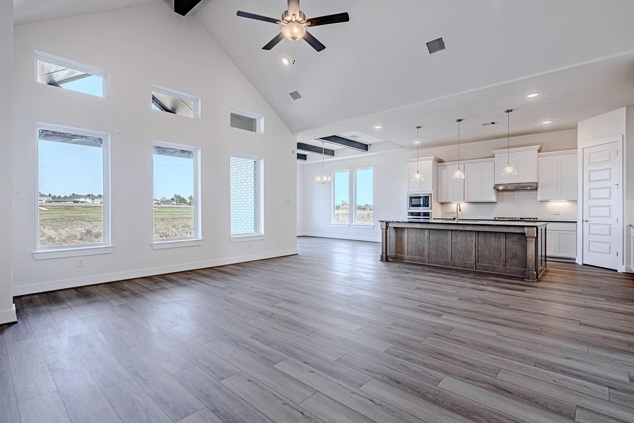 Image 2: Primary living area with high ceilings, ceiling fa
