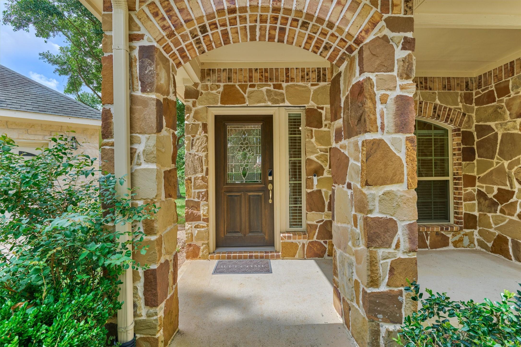 Image 3: An inviting entry greets guests with a leaded-glas