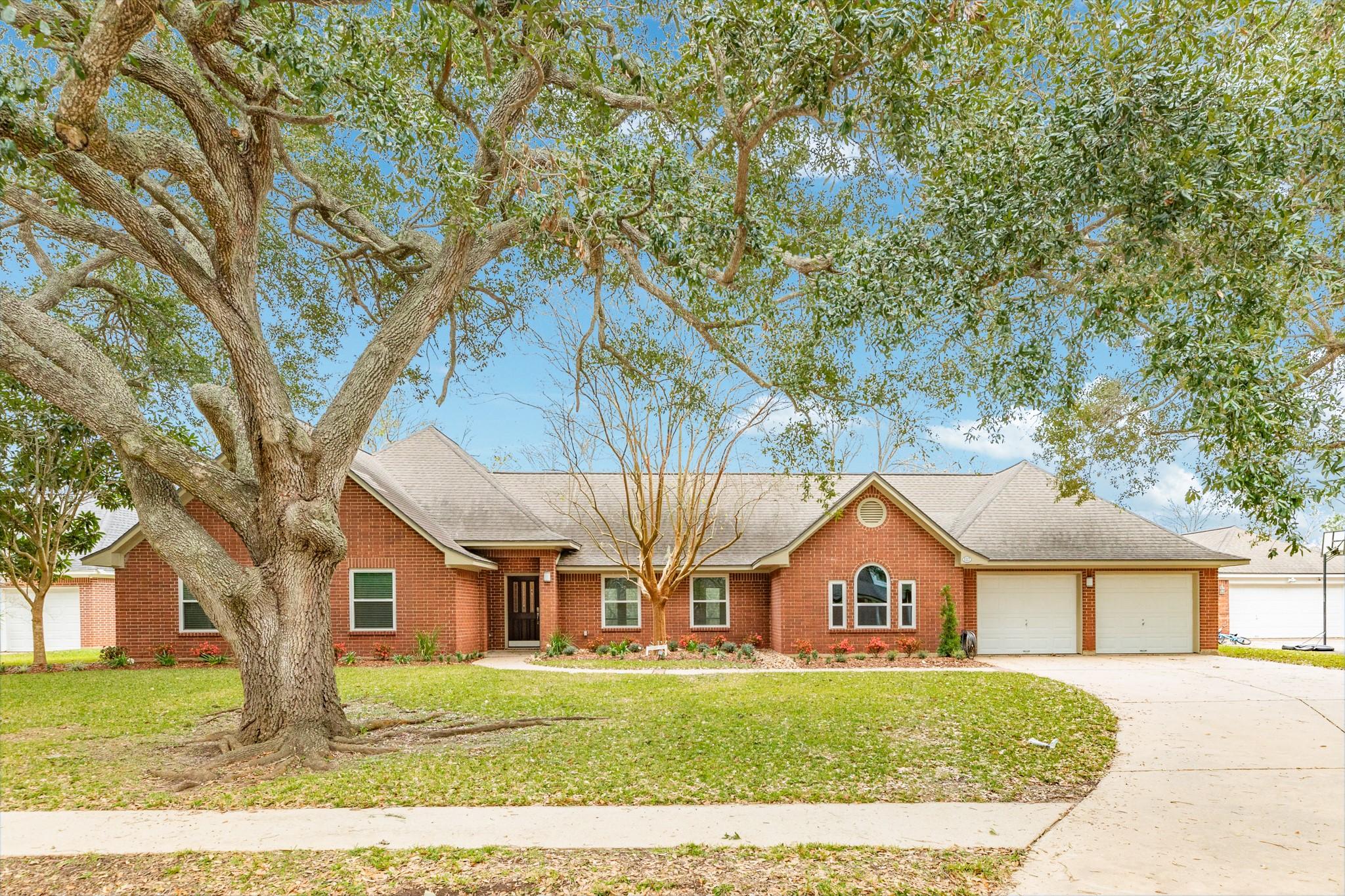 Image 1: Charming brick home with a spacious front yard, sh