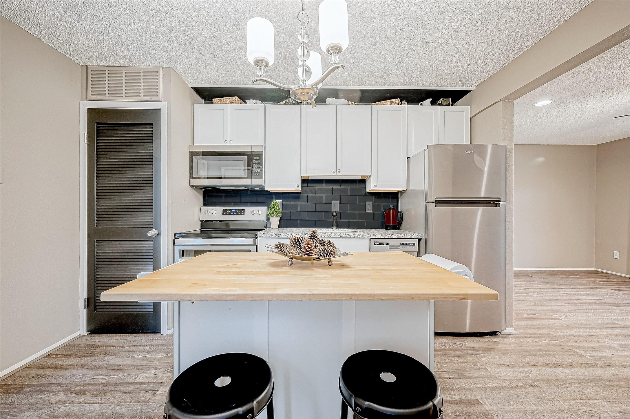 Image 2: Spacious kitchen opens up to the family room