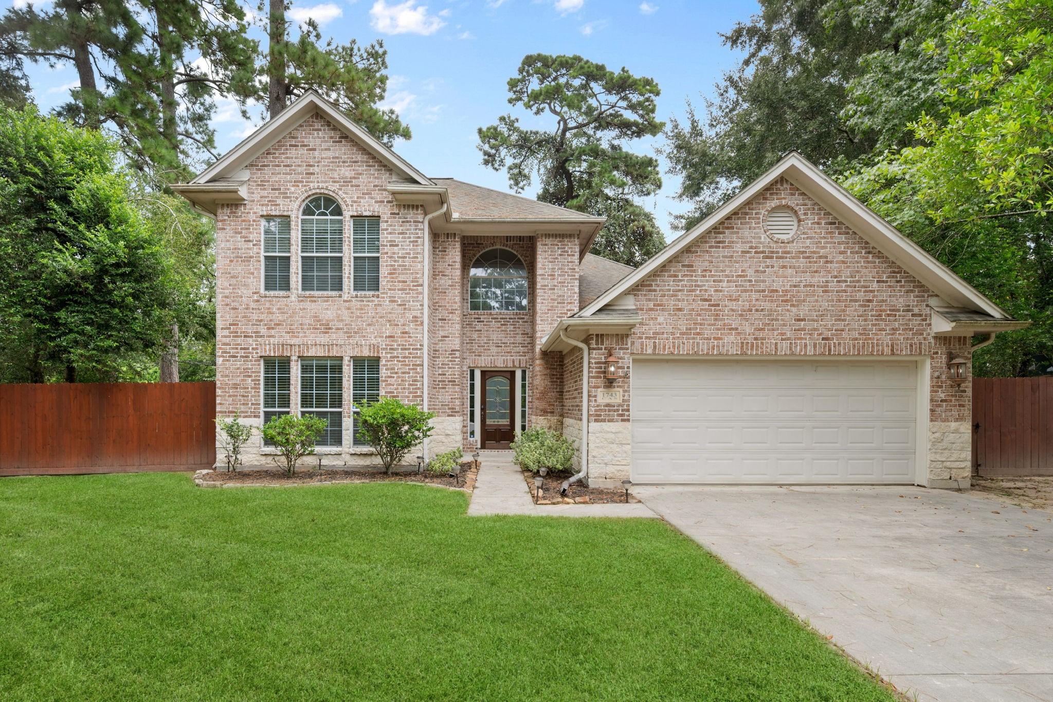 Image 3: A charming two-story brick home with a spacious dr