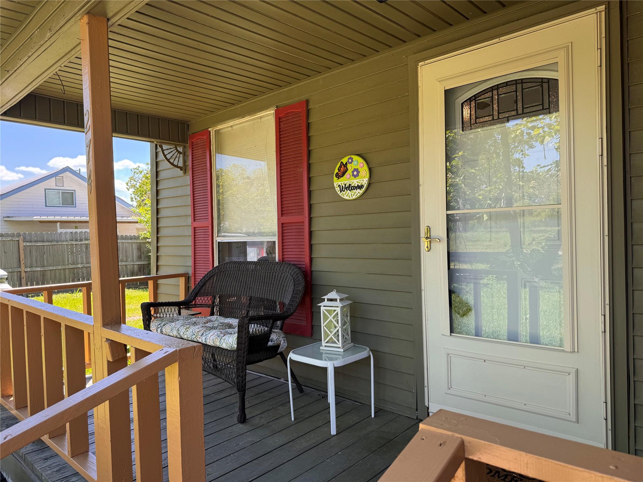 Image 3: Charming front porch with a cozy wicker bench, dec