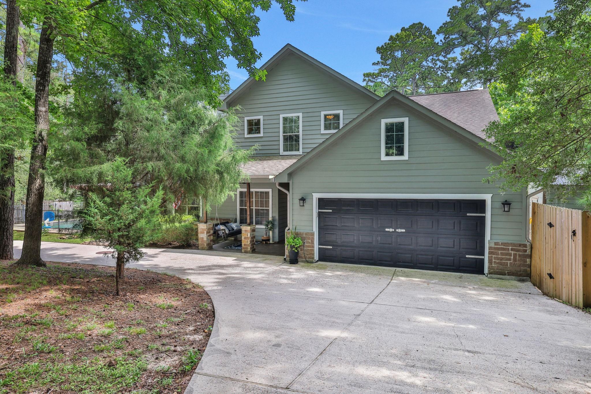 Image 3: The two car attached garage plus circle driveway p